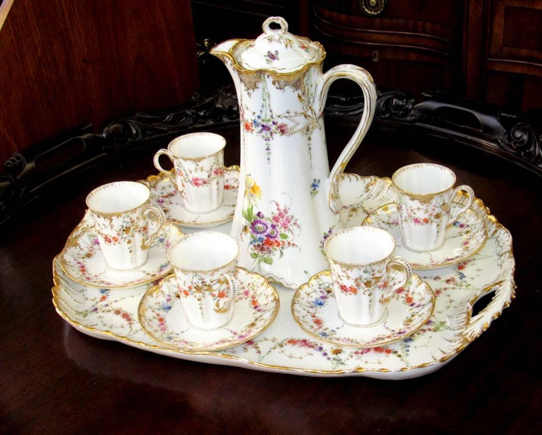 Fabulous quality antique French Haviland Limoges hand-painted porcelain chocolate set with rare cabaret tray, chocolate pot and five cups and saucers.

Please note exceptional hand-painted floral garlands and sprays with initials by artist