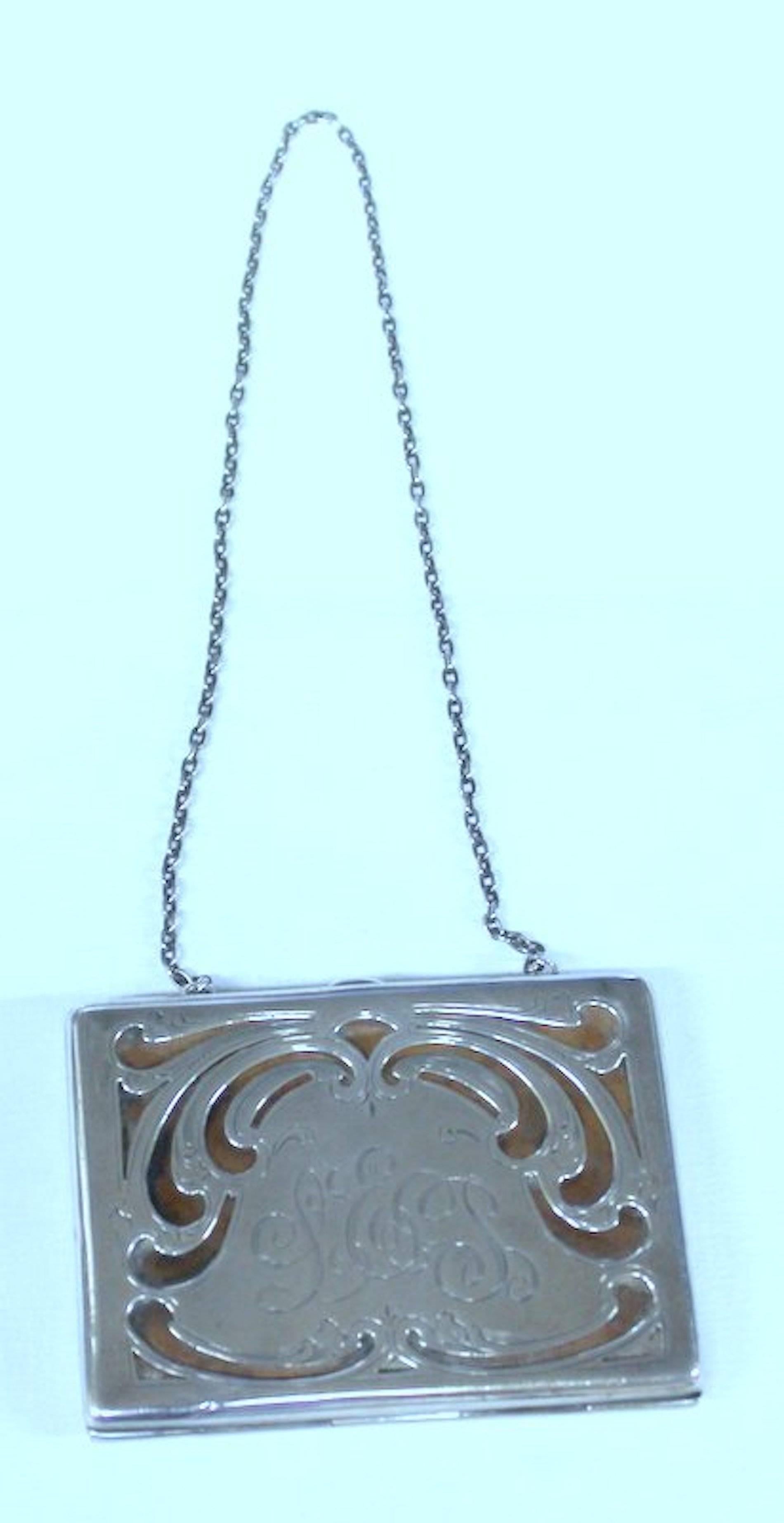 Superb old American hand pierced and engraved sterling card case or coin purse with chatelaine chain.
Please note superbly pierced, engraved and monogrammed purse with original calfskin leather interior.
  