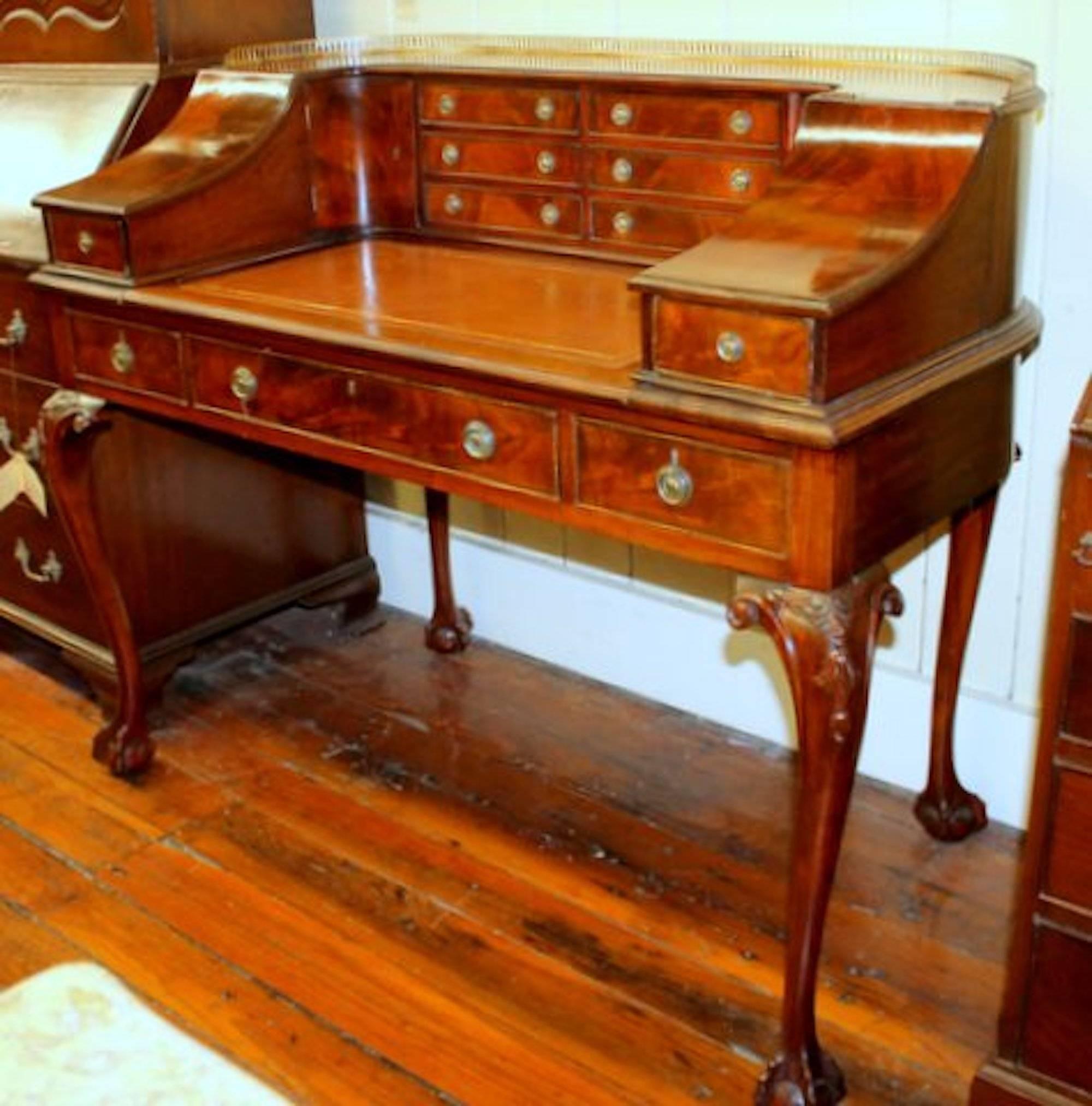 Exceptional quality antique English Chippendale style hand-carved flame mahogany Carlton House desk

Measures: 23 3/4" H (kneehole clearance)

Please note handsome cabriole legs with "bellflower" carving on the knee. Also note the