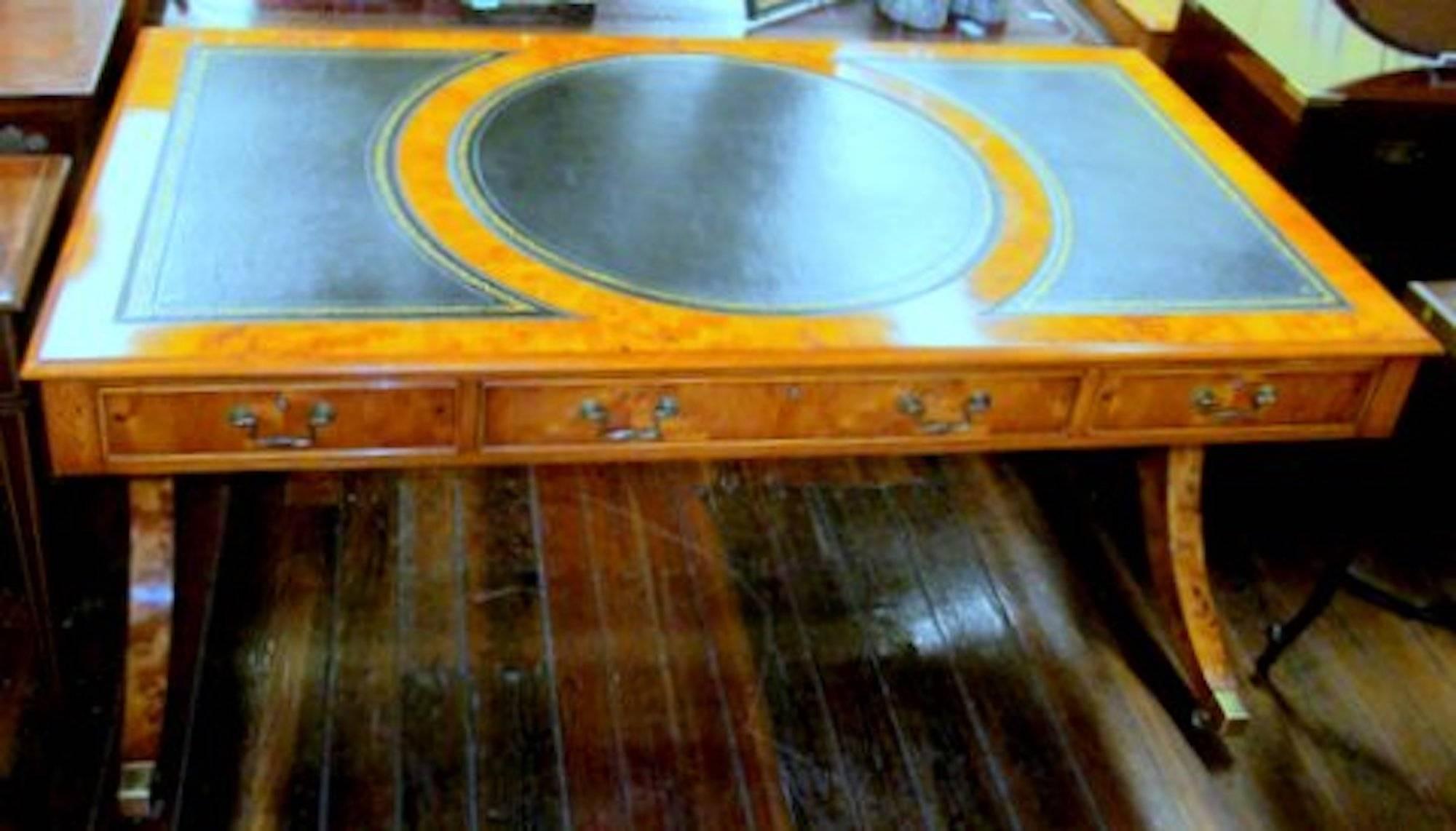 Finest quality English bench made inlaid yew-wood regency style partner's bureau plat writing table with tooled and gilt leather hide writing surface. Please note that this 