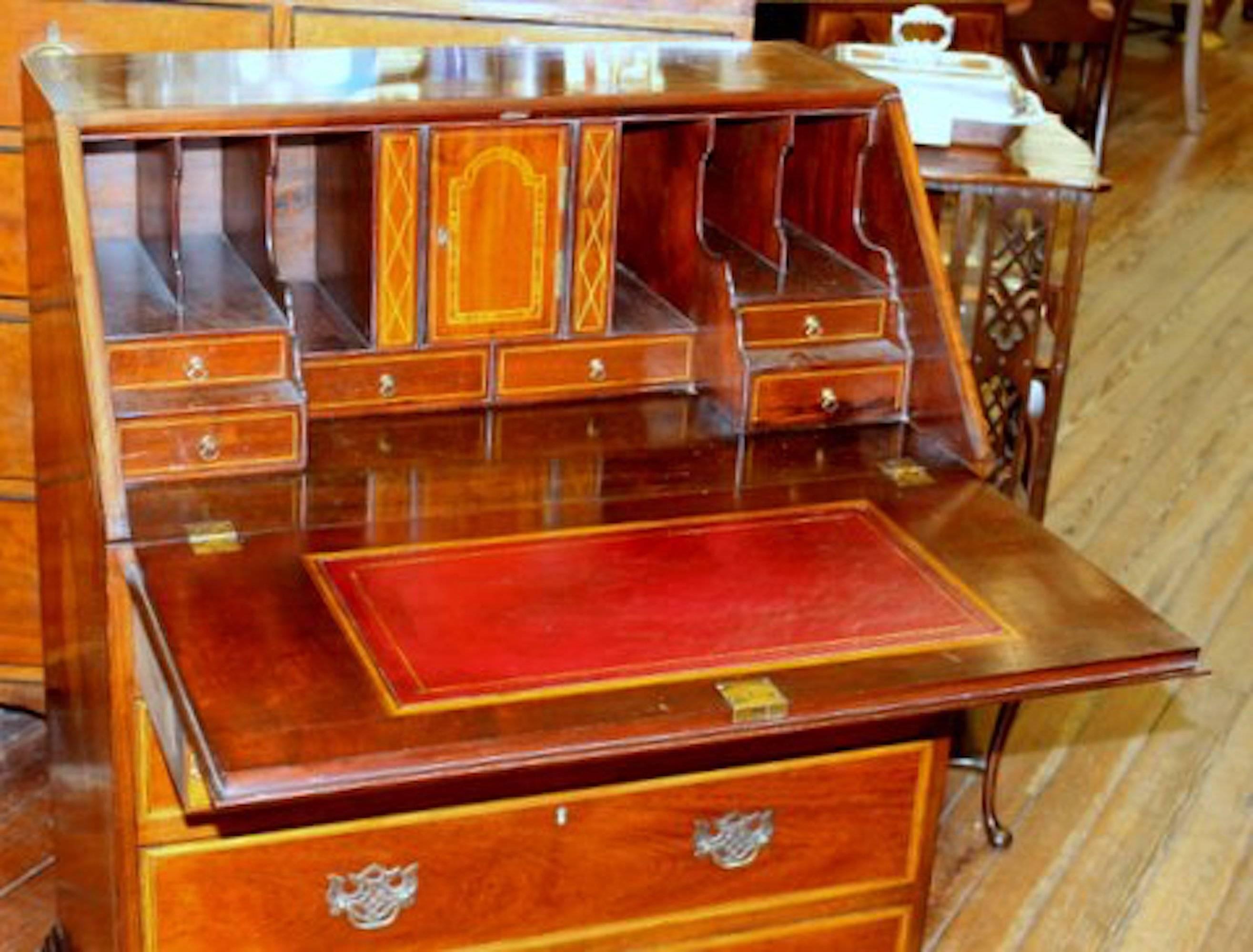 Exceptional quality antique English fabulously inlaid figured mahogany Georgian style small slant-front bureau with handsome fitted interior and leather writing surface

Please note extraordinary satinwood and rosewood inlays throughout, in