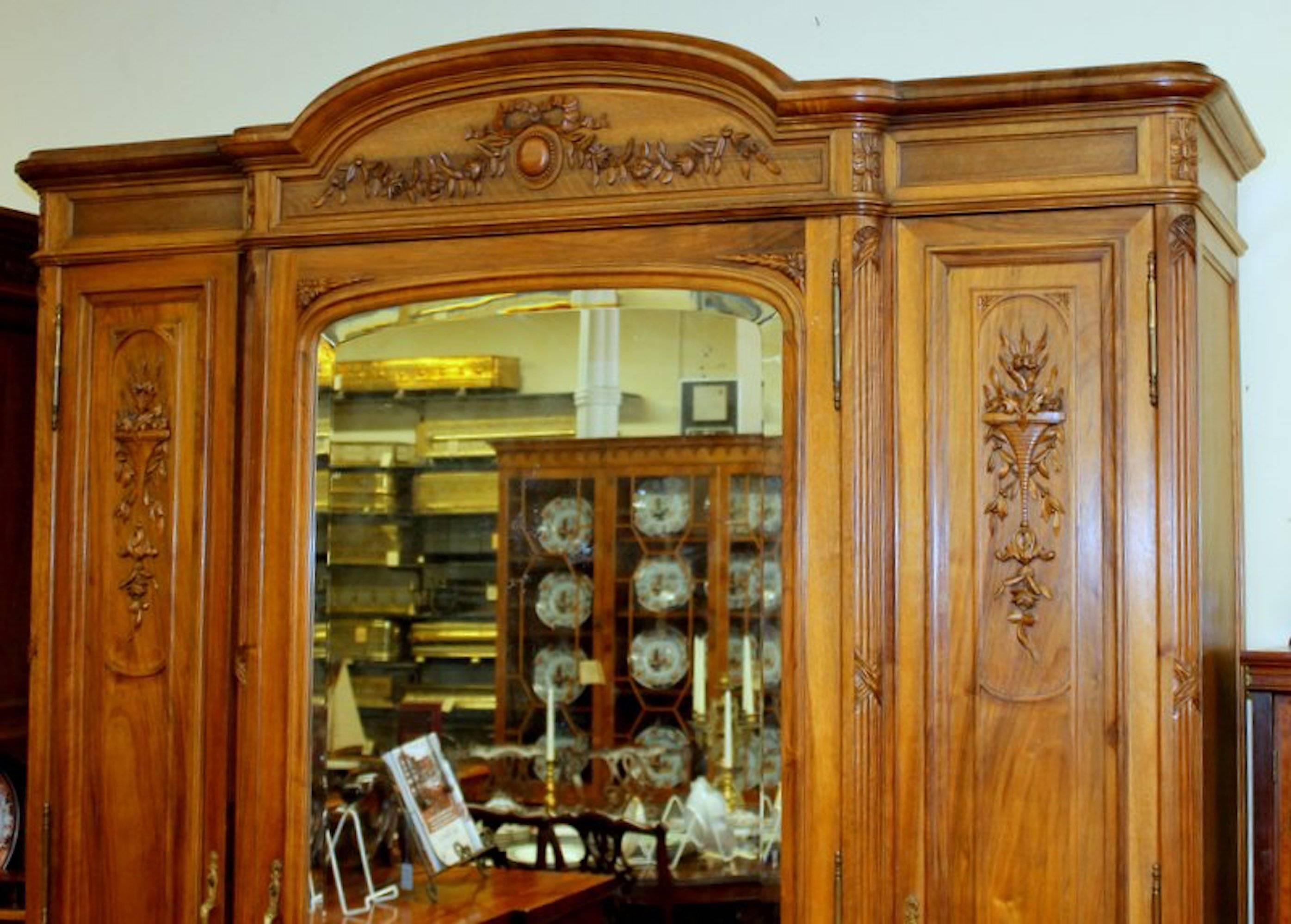 Fabulous quality Old French hand-carved walnut compactum wardrobe with original mirrored doors and hardware. Amazing amount of space.