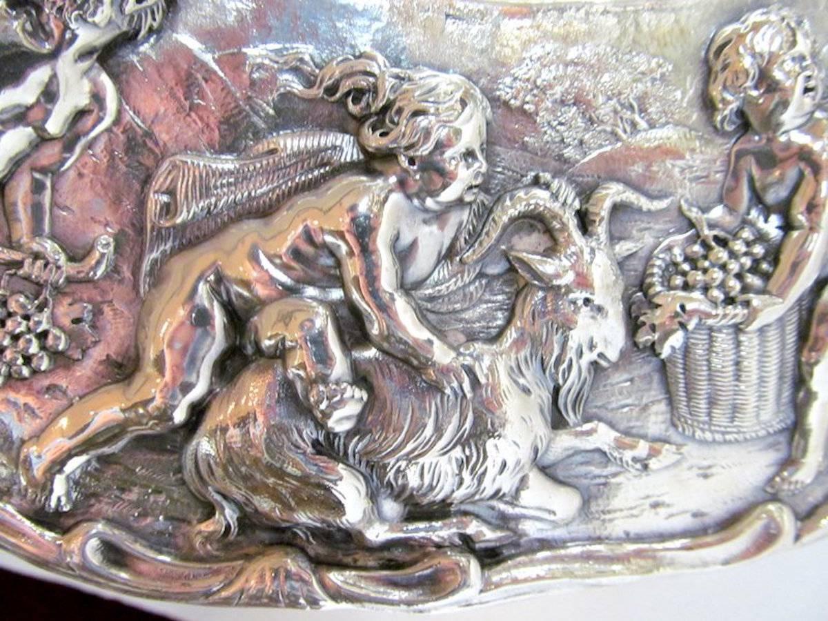 Rare and important antique English Geo. IV sterling silver sideboard dish with exceptionally hand chased and cast allegorical mythological border. 
Please note the bas relief hand chased allegorical border and central cypher hand chased for Queen