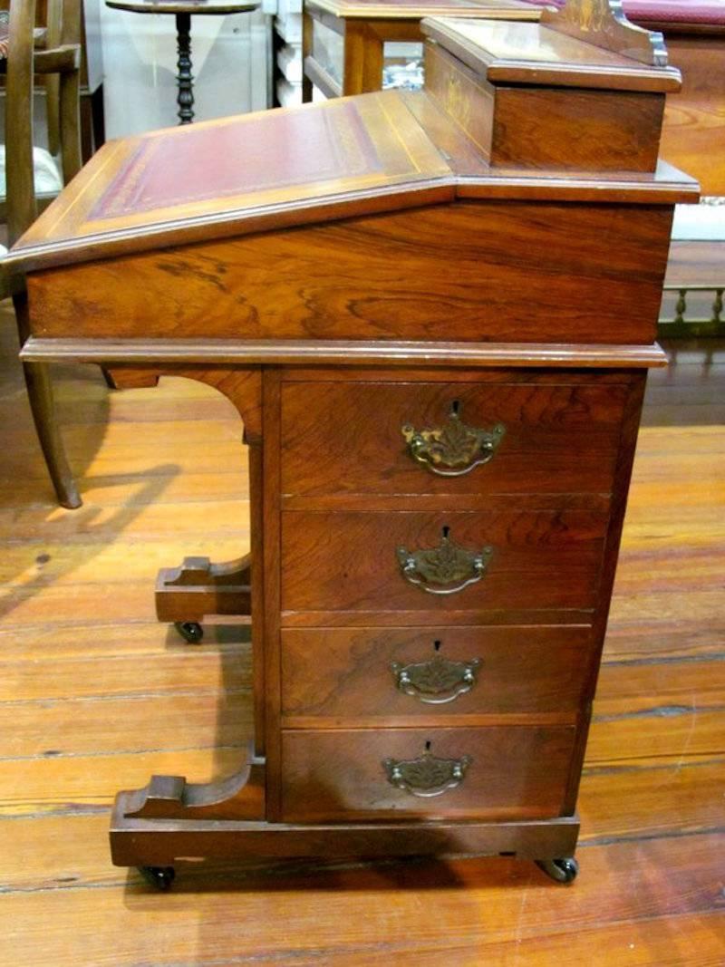 Fabulous quality antique English marquetry inlaid rosewood davenport or ship captain's desk.

Please note superb "Adam" style neoclassical urn inlays, fitted interior on top, bank of drawers to right side and faux drawers to left side.