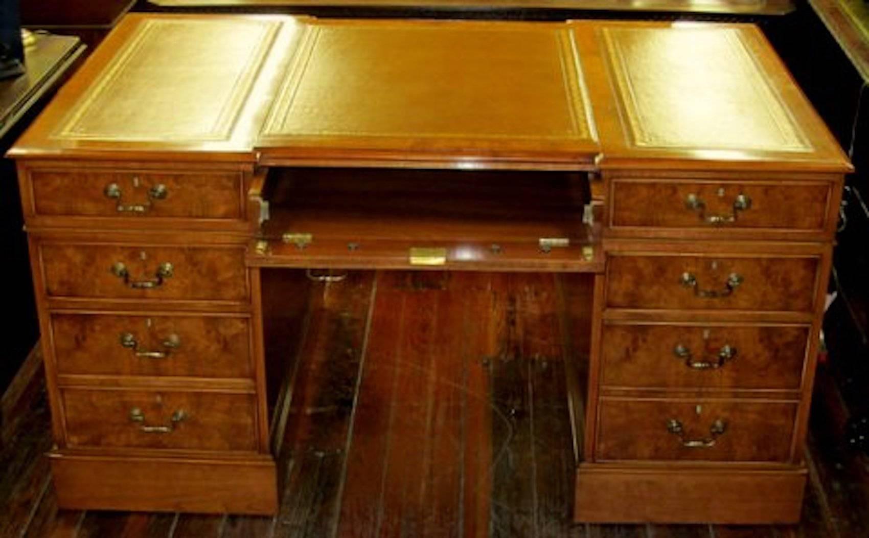 Superb quality English bench made inlaid burr walnut Chippendale style leather top pedestal partner's desk, antique copy. Please note handsome hand tooled and gilt leather; lower right hand file drawer; drop-down centre keyboard drawer with 