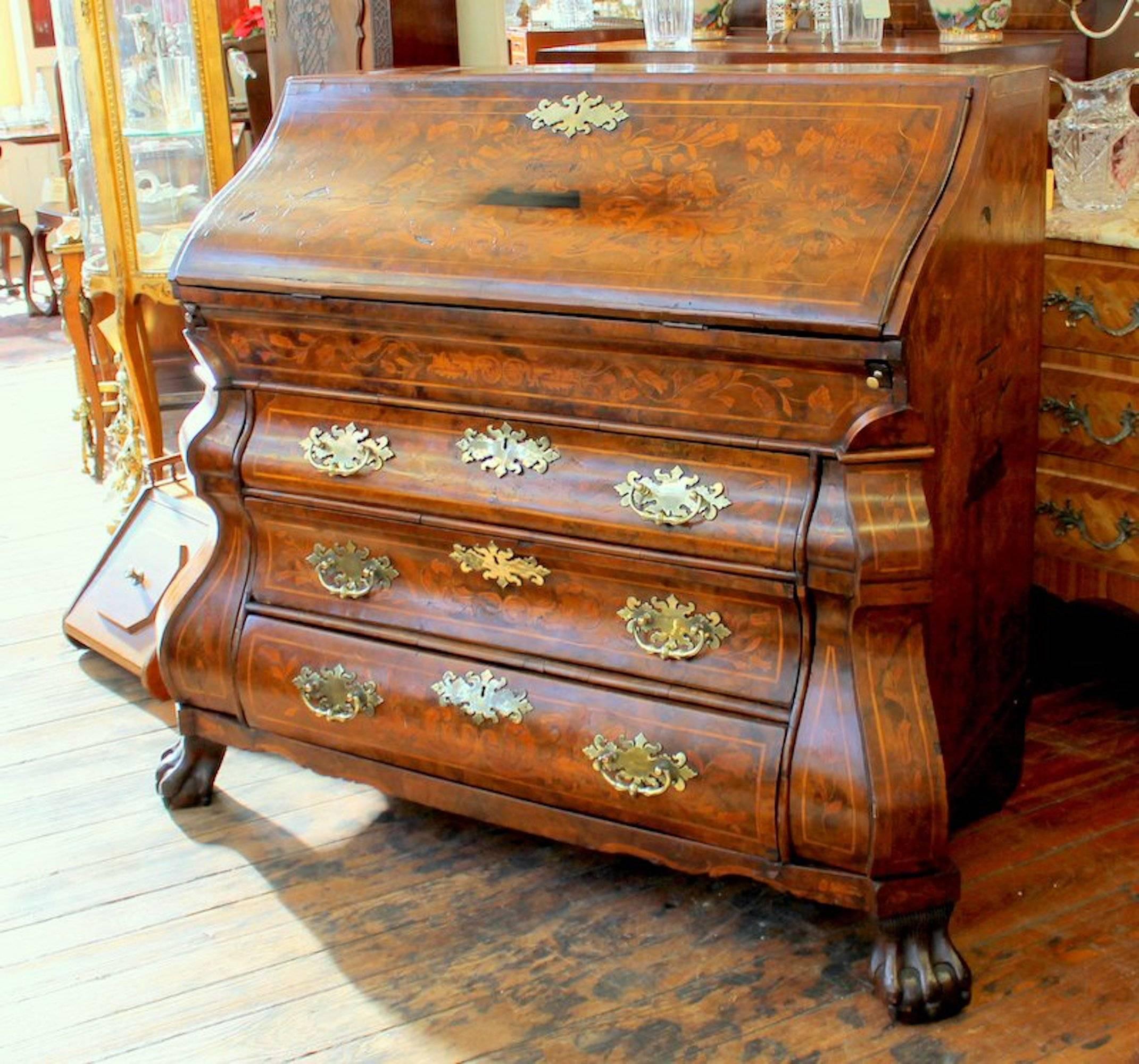 Finest antique Dutch marquetry inlaid burr walnut bombe' shape slope-front bureau with exceptional fitted interior and baize writing surface

Please note extraordinary cast brass handles and escutcheon plates. It has many interior 