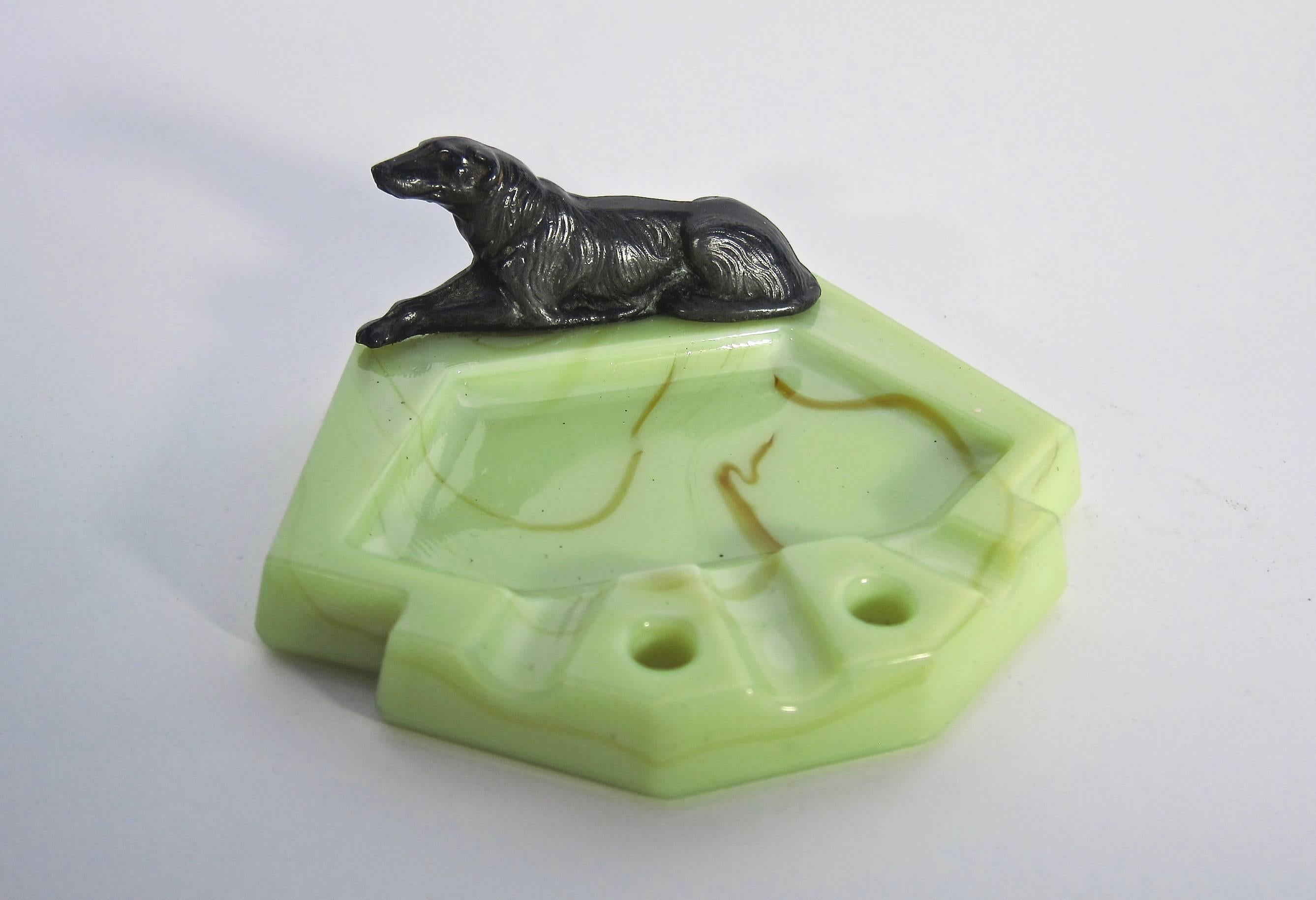 A stylish catchall dish from the Art Deco period, designed in green slag glass with butterscotch swirl accents and an elegant Borzoi/Russian Wolfhound in patinated cast silver metal mounted at edge. Originally an ashtray, the dish is a perfect