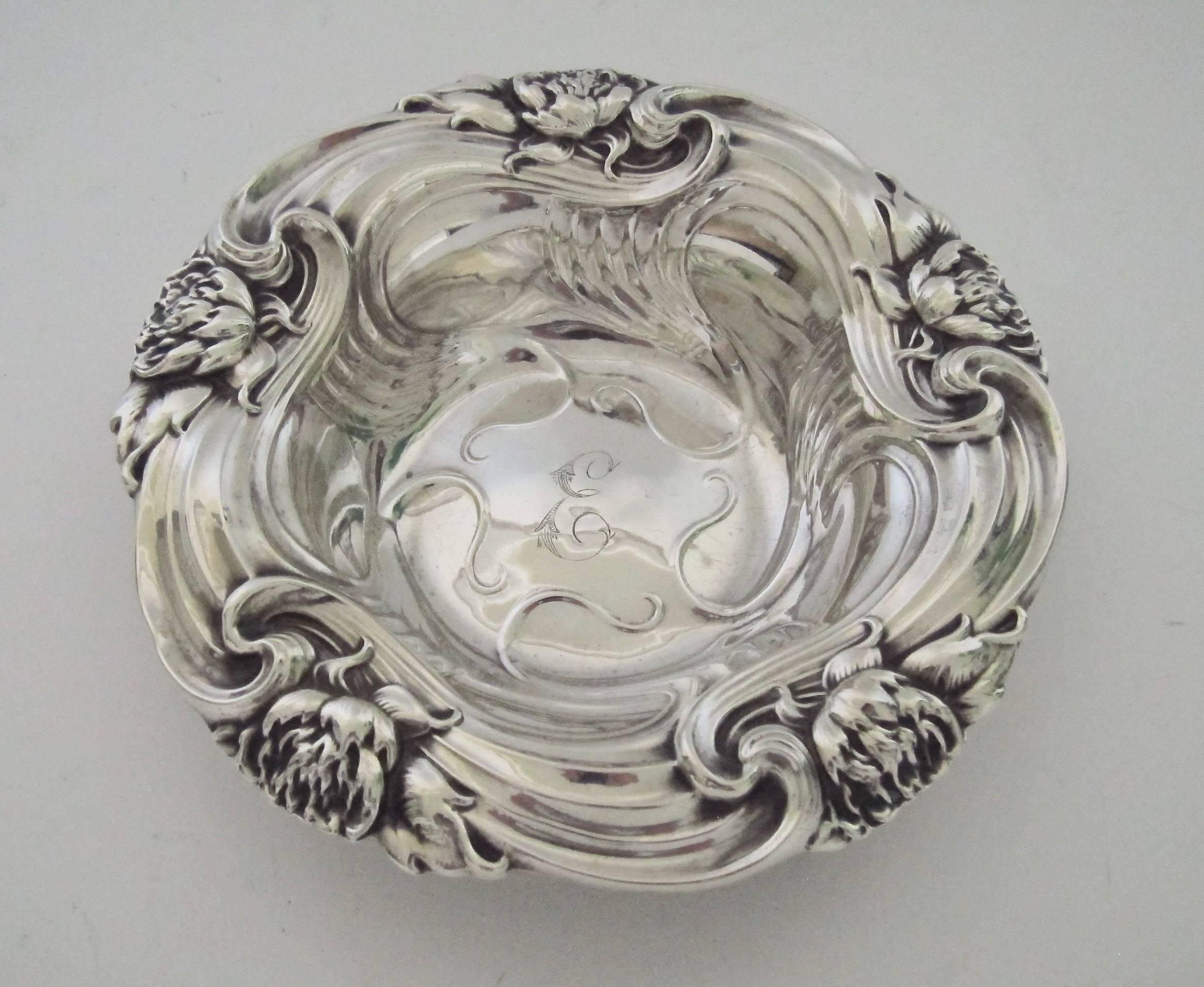 An antique sterling silver bon bon dish manufactured by the successful New York silversmiths at Whiting Manufacturing Company. The bowl is ideal for serving candy or nuts and is perfectly sized for use as a wine bottle coaster. 

Bold Art Nouveau