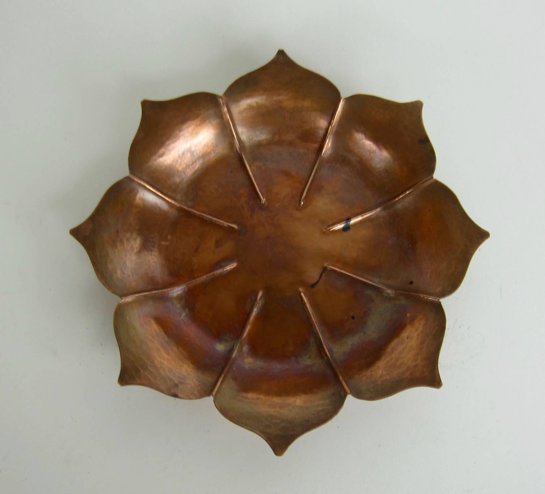 An American Arts and Crafts era fluted and flaring lotus form dish or shallow bowl hand-crafted by Marie Zimmermann (1879-1972). The piece comes directly from this American metalworker's estate and dates circa 1920.

The design is a simple and