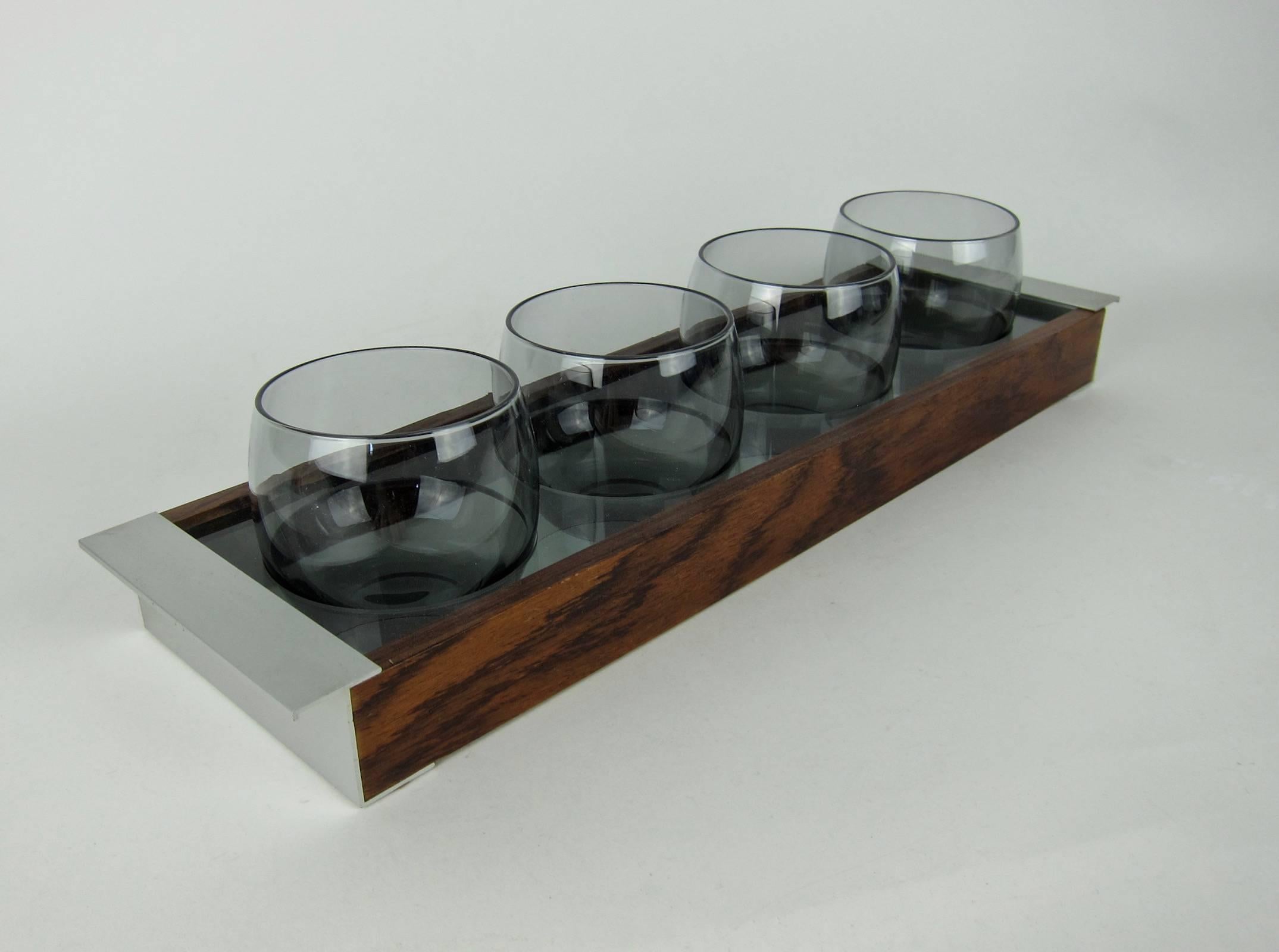 A stylish Scandinavian Modern glassware caddy with four roly-poly glasses from Design Philipp of Sweden, a former Royal Warrant Holder of the Swedish Court.

The tray is made of handsome, light-weight grained wood with contrasting handles of brushed