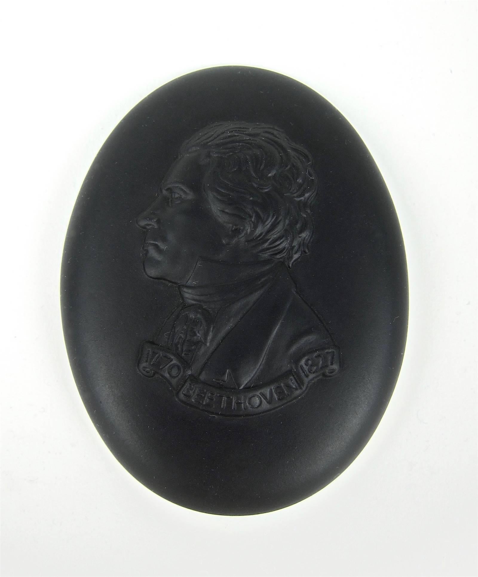 A Wedgwood portrait medallion of German composer and pianist, Ludwig van Beethoven, made in England in 1970. The oval plaque is crafted in Wedgwood's black basalt (stoneware), a material developed by Josiah Wedgwood in 1768. 

The medallion