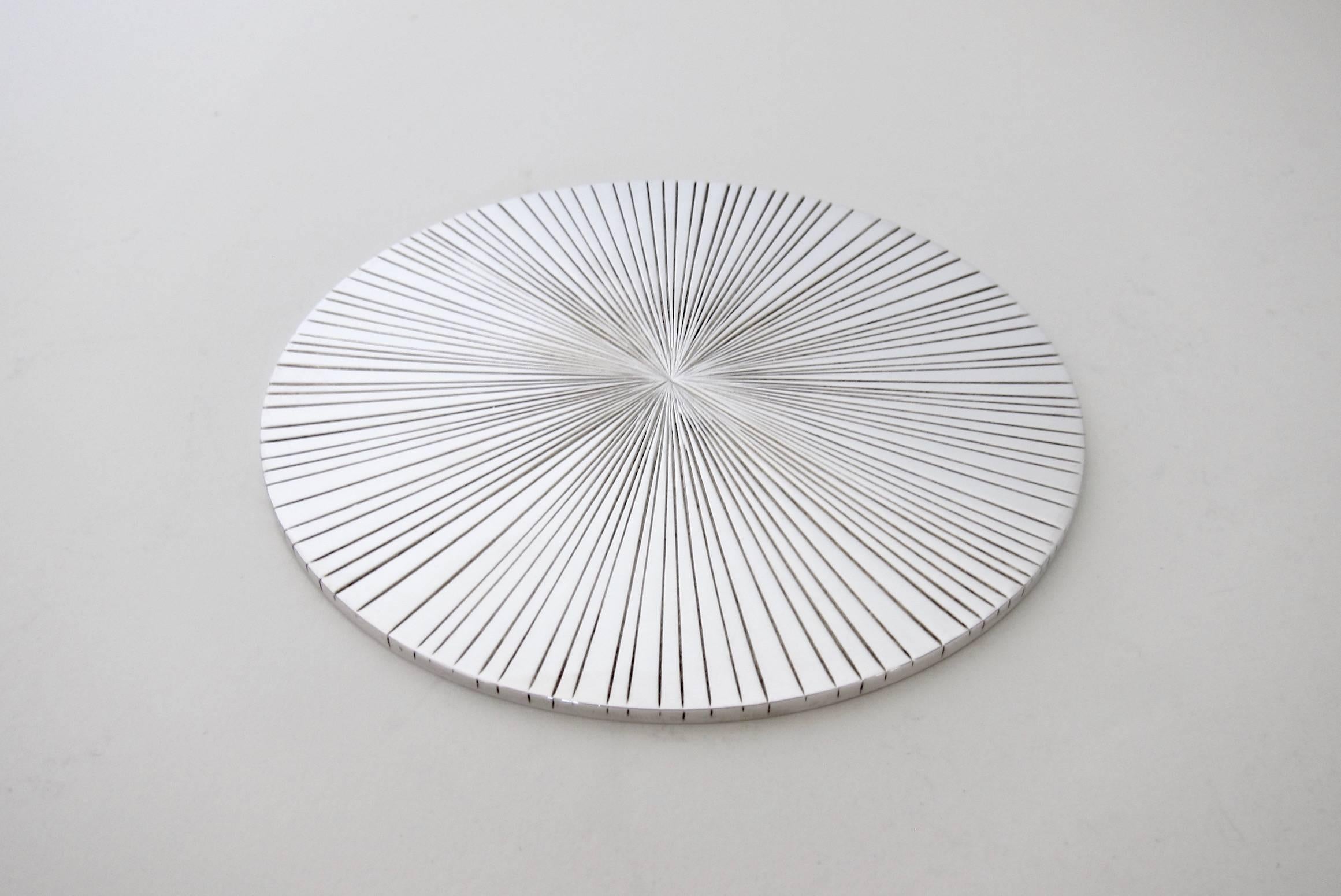 An exquisite wine bottle coaster from the Christofle Palm Collection, designed by Michele Oka Doner (b.1945) in 2003. Palm tree fronds inspired this collaboration and the design features incised lines (veins) radiating outward from the