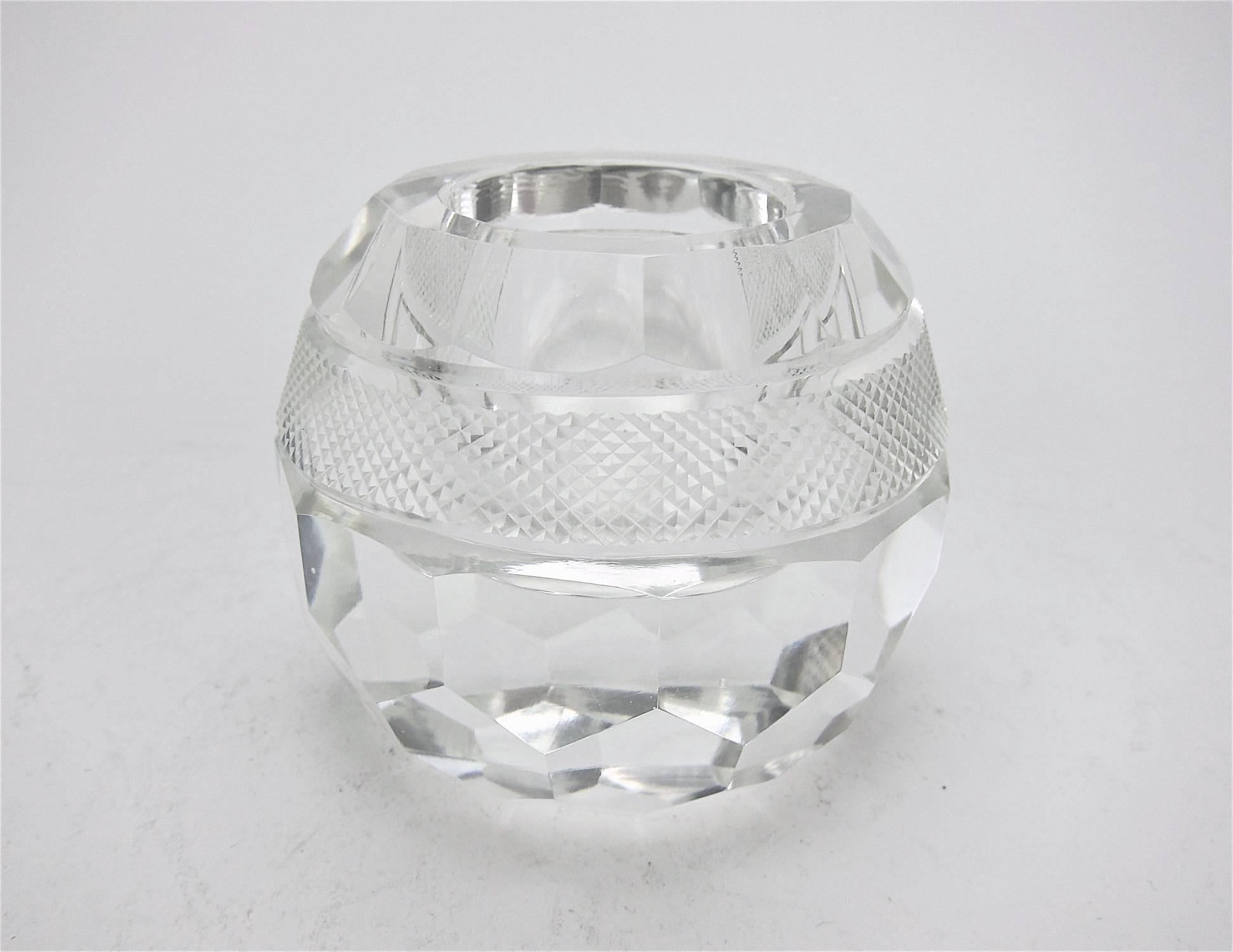 A vintage match holder and striker in heavy, faceted crystal. Unmarked, but likely produced by Webb Corbett of England. Very good condition with some wear on base including a few shallow scratches, measuring 2.75 in. H x 3.25 in. diameter.