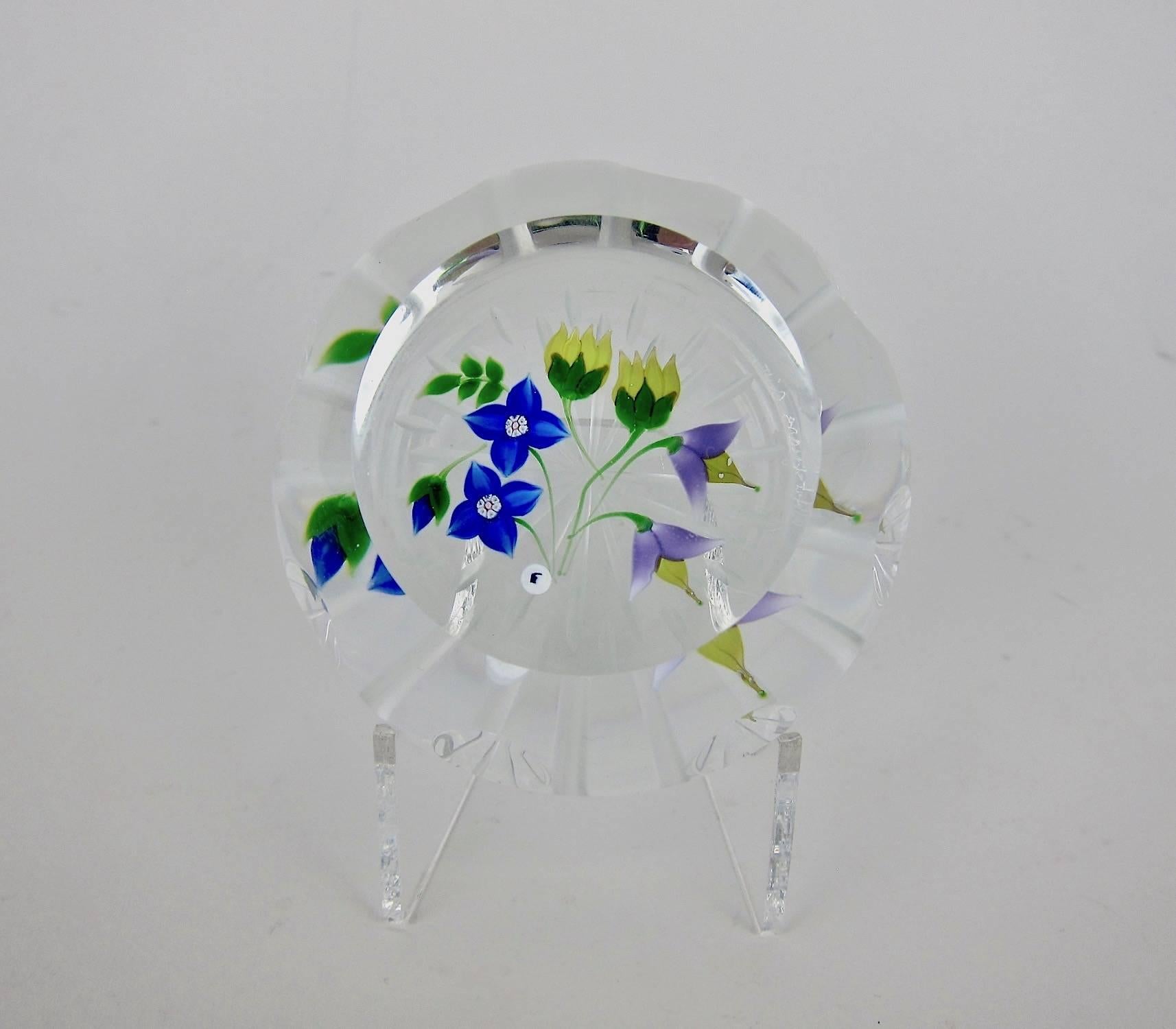 A handcrafted studio glass paperweight from Whitefriars Caithness of Scotland, designed by Allan Scott in 1986 in a limited edition of 250. The multi-faceted 