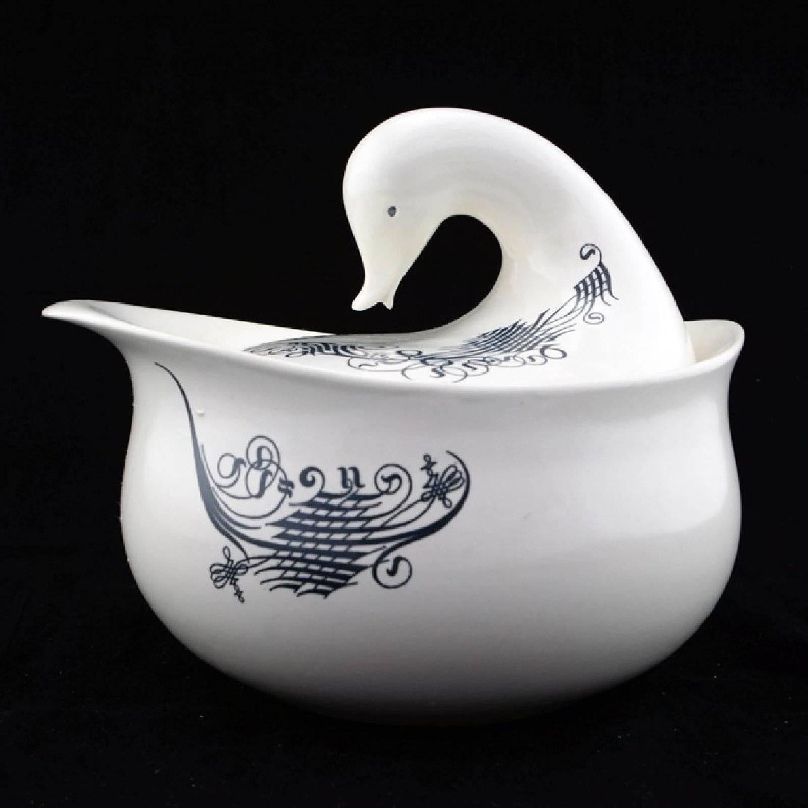A large midcentury covered serving bowl or casserole designed by Eva Zeisel (1906-2011) for Schmid International in the 'Lyric' pattern featuring an abstract black linear pattern against a warm white ground. The whimsical bird-shaped duck or goose