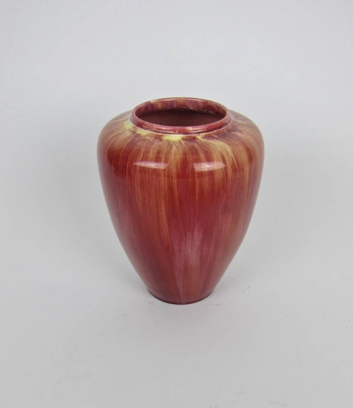An English Arts & Crafts era earthenware vase from Pilkington's Tile and Pottery Company of Clifton Junction, Manchester, marked 1907. The antique art pottery vessel has a depressed shoulder and wide mouth enveloped in a glossy flambe glaze of