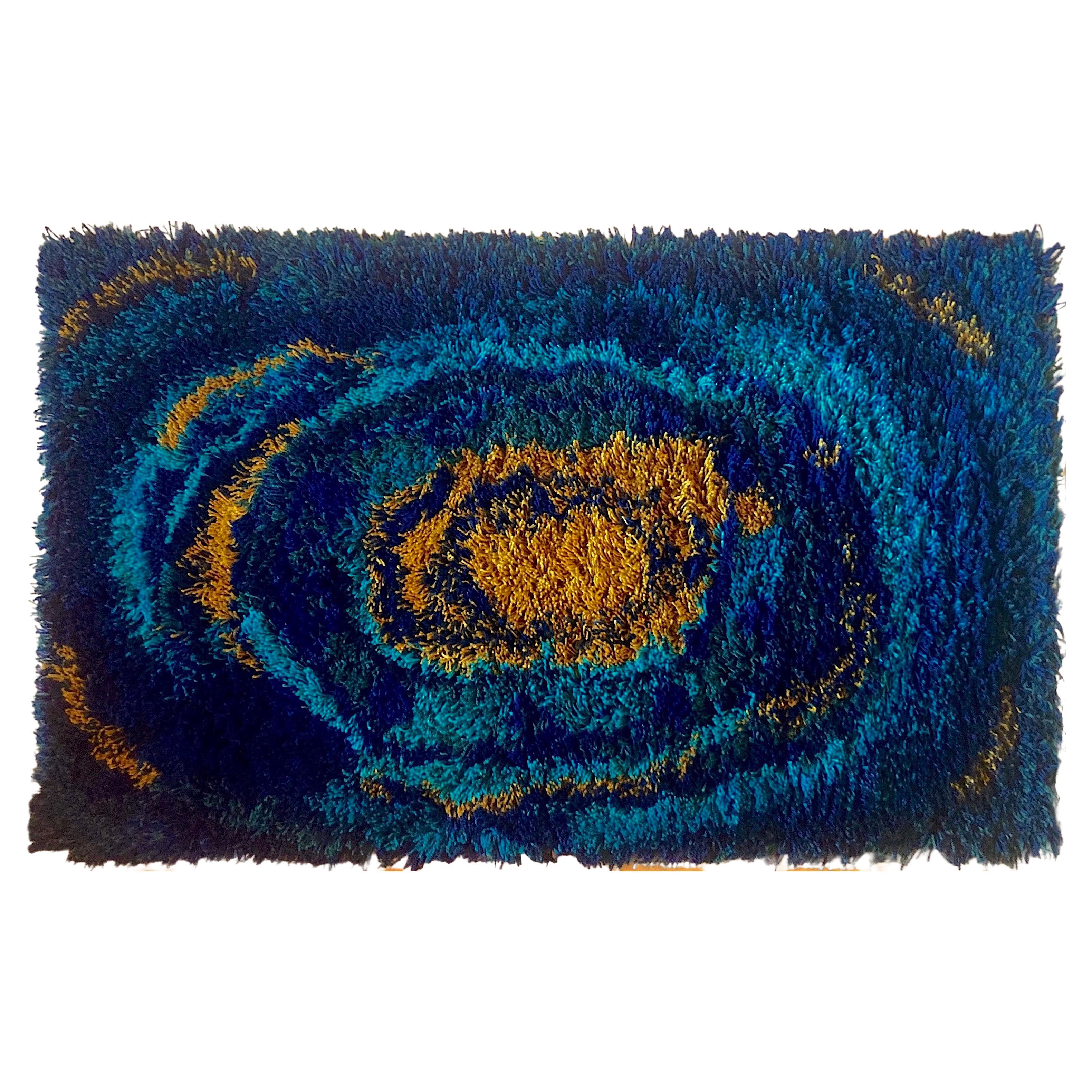 A vintage Scandinavian rya rug designed in the 1960s for EGE Rya De Luxe, a subsidiary of Denmark's most prestigious carpet manufacturer, EGE Taepper. This deep and dense midcentury design is 100% thick wool shag in a swirling abstract pattern,