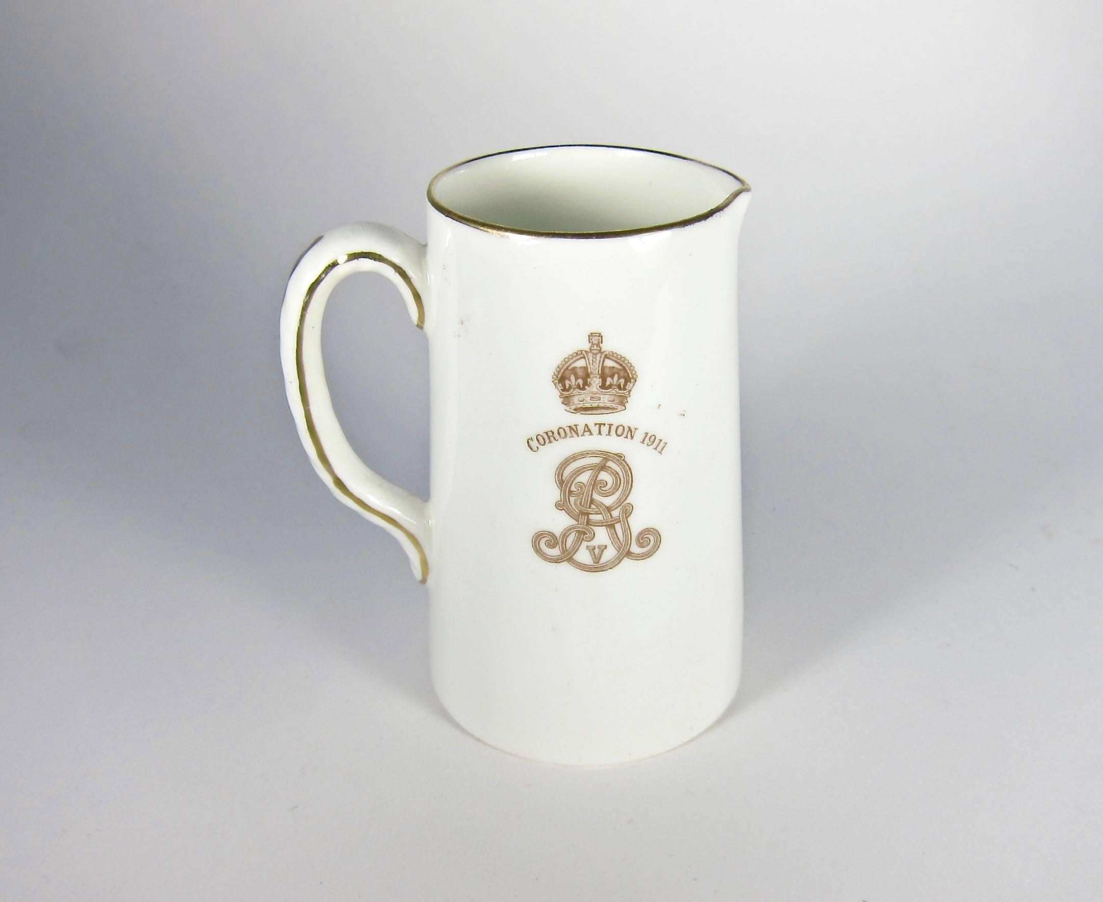An English Royal Doulton antique ceramic pitcher sized for milk or cream commemorating the 1911 coronation of King George V and Queen Mary. Decorated with a transfer printed double oval portrait of the King and Queen; reverse shows their entwined