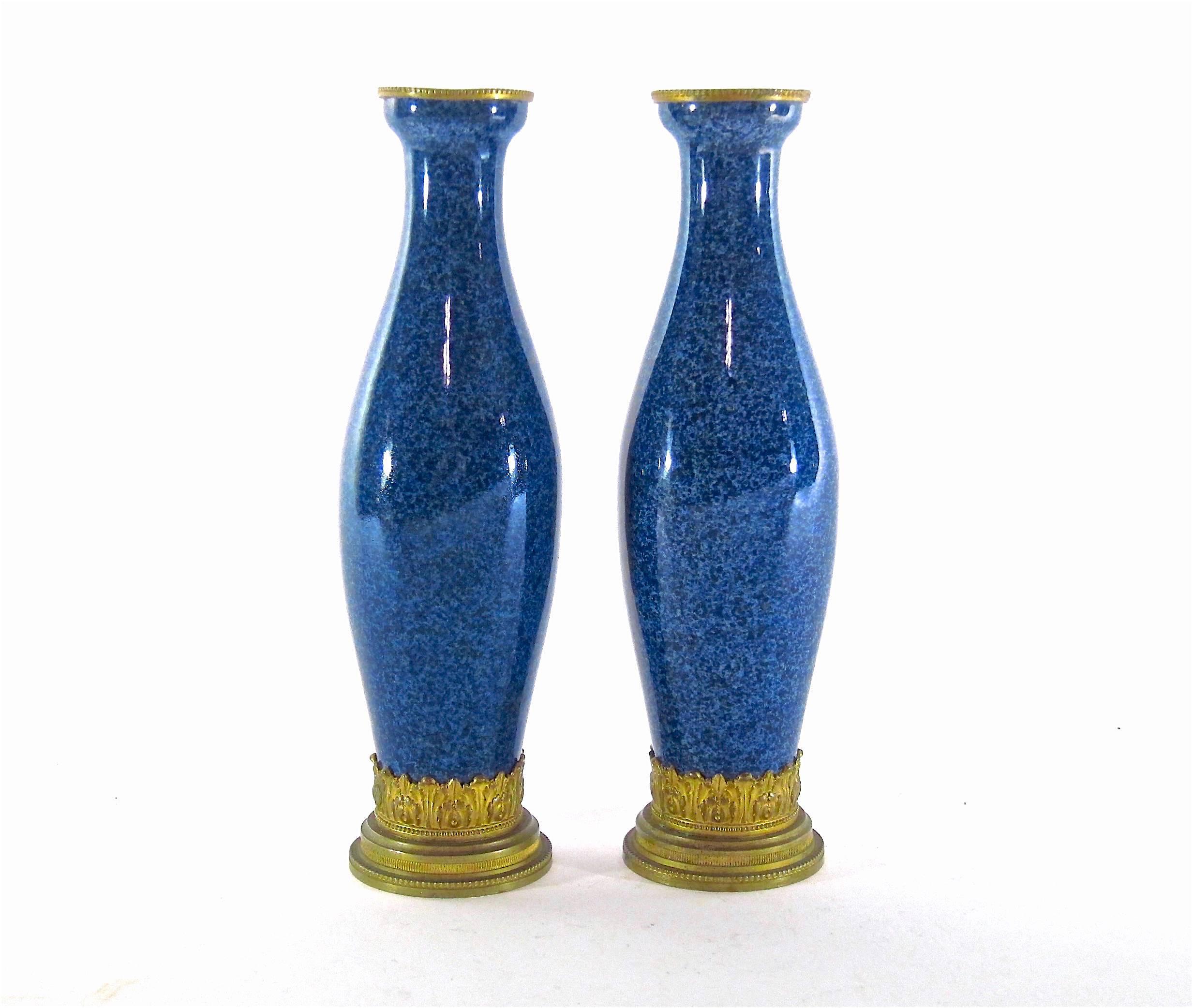 An antique pair of glazed faience cabinet vases with contrasting mounts of ormolu in the French Neoclassical style, designed by Paul Jean Milet (1870-1950) for the Paul Milet Pottery at Sèvres, France, circa 1915. 

Decorated with a sophisticated