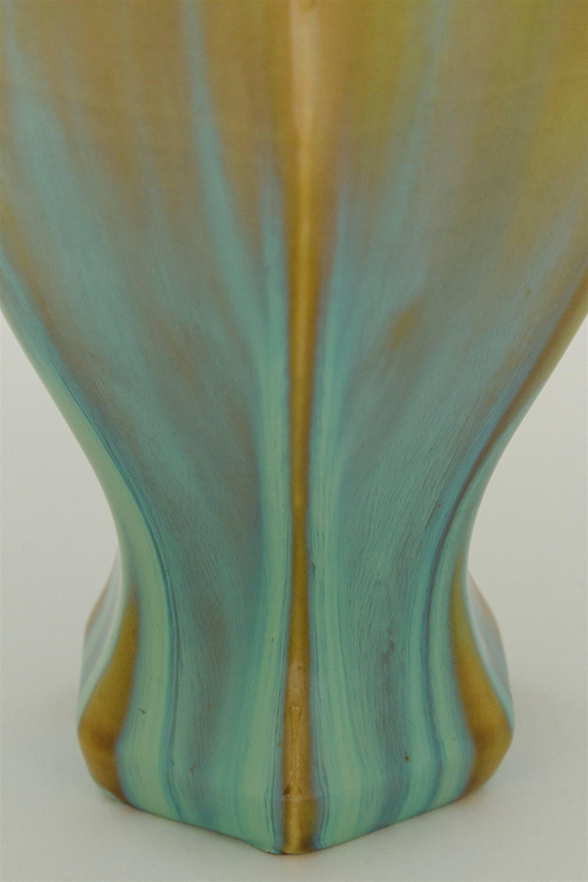 An early 20th century tall, hexagonal Arts and Crafts vase from Fulper Pottery of Flemington, New Jersey. The vase is Fulper's 660 form, decorated with a vibrant flambe glaze in contrasting shades of frothy green and golden brown. 

Marked