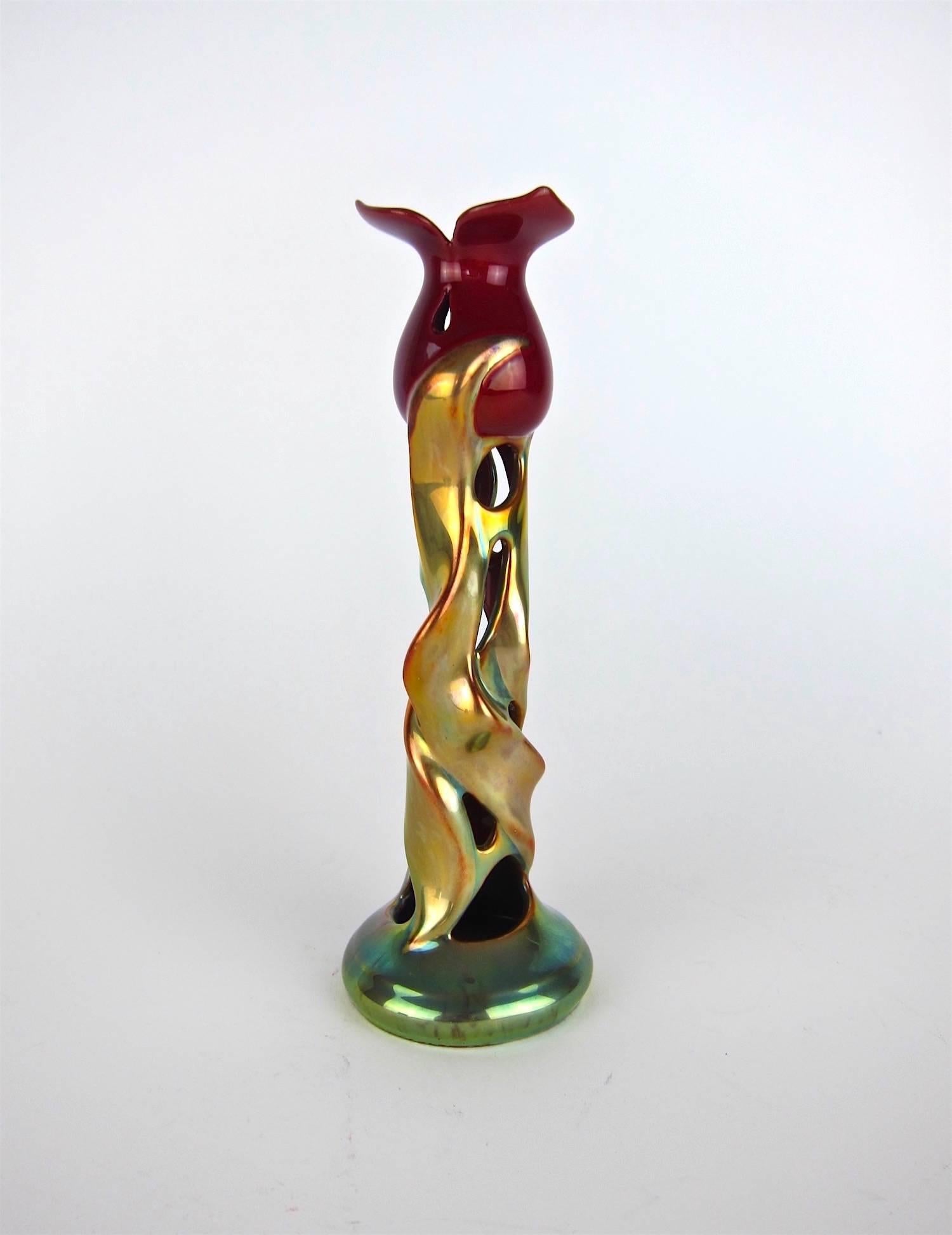 A stunning Zsolnay Pecs porcelain tulip candlestick with a metallic luster gold and green glaze, designed in the turn of the 20th century high Art Nouveau / Jugendstil style. The candlestick is illustrated on page 185 of Federico Santi and John