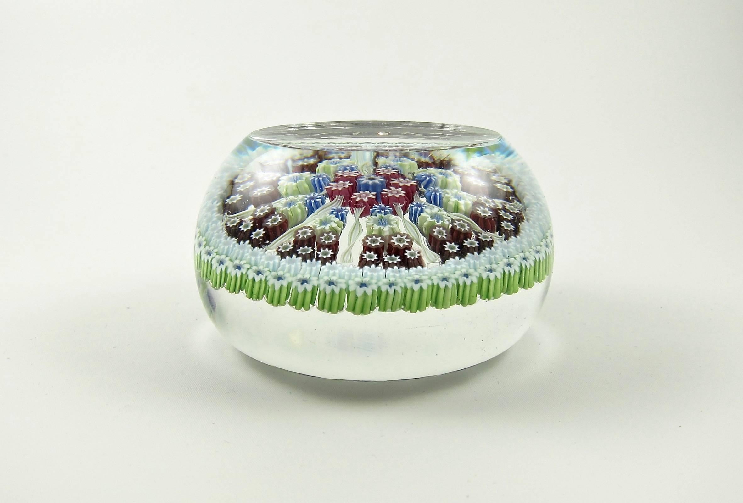A limited edition art glass paperweight handcrafted at Perthshire paperweights of Crieff, Scotland between 1976 and 1978. The weight is composed of a decorative millefiori design interspersed with nine radiating latticinio twists with Perthshire's