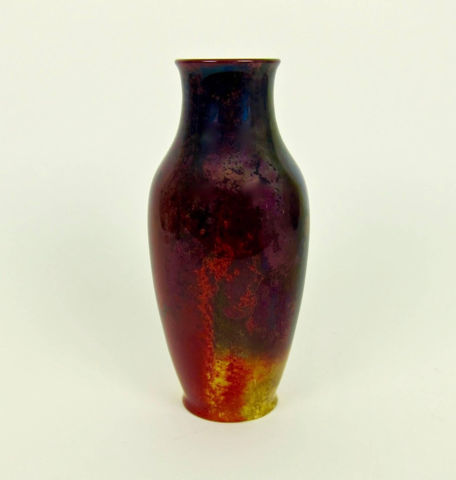 A large English Art Deco era Royal Doulton flambé vase artist signed by Harry Nixon (1886 - 1955), circa 1930. The baluster form vessel has a high-fired flambé glaze of deep, dark reds shading to violet, black and mottled gold.

Nixon worked closely