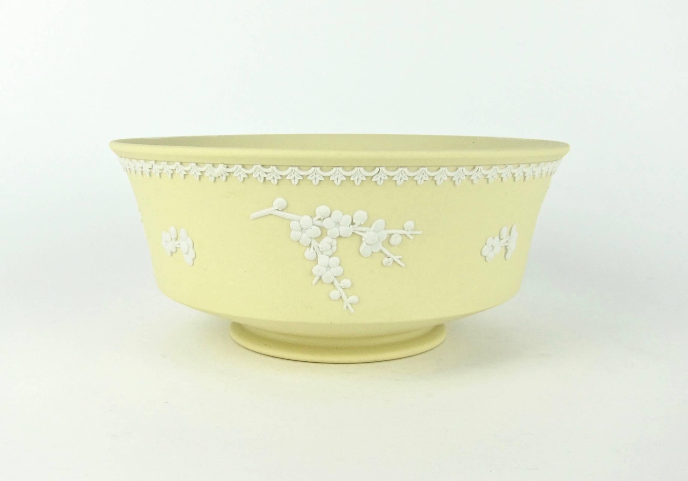A vintage English Wedgwood footed bowl in solid Primrose yellow jasper decorated with white bas-relief in the Prunus pattern. Made in England in 1976 and illustrated on page 172 of Wedgwood Ceramics, by Daniel J. Keefe III, 2005. 

The