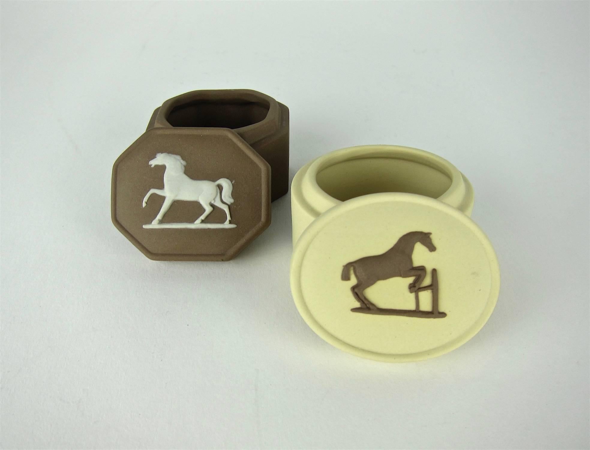 Two Wedgwood Equestrian boxes in solid Taupe and Primrose Jasper decorated with applied, bas-relief horse figures based on studies by painter, George Stubbs. Edward Burch R.A. modeled the horses for Josiah Wedgwood in the late 1780s. 

The octagonal