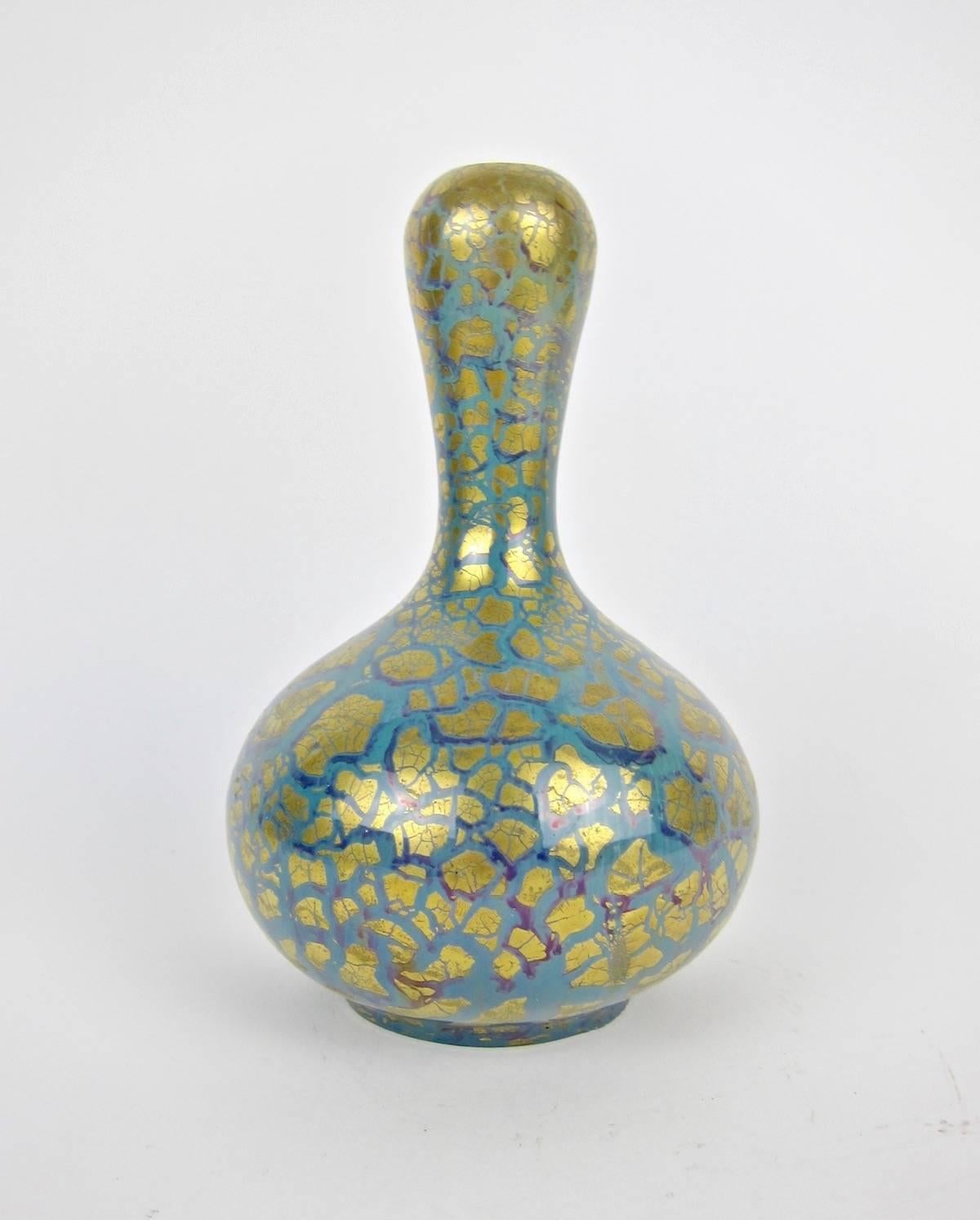 An early 20th century French art pottery vase with a golden metallic glaze, made by Joseph and Pierre Mougin Frères in Nancy, France between 1906 and 1916. Decorated with an organic Art Nouveau decor scheme of hand-painted tendrils of blue with