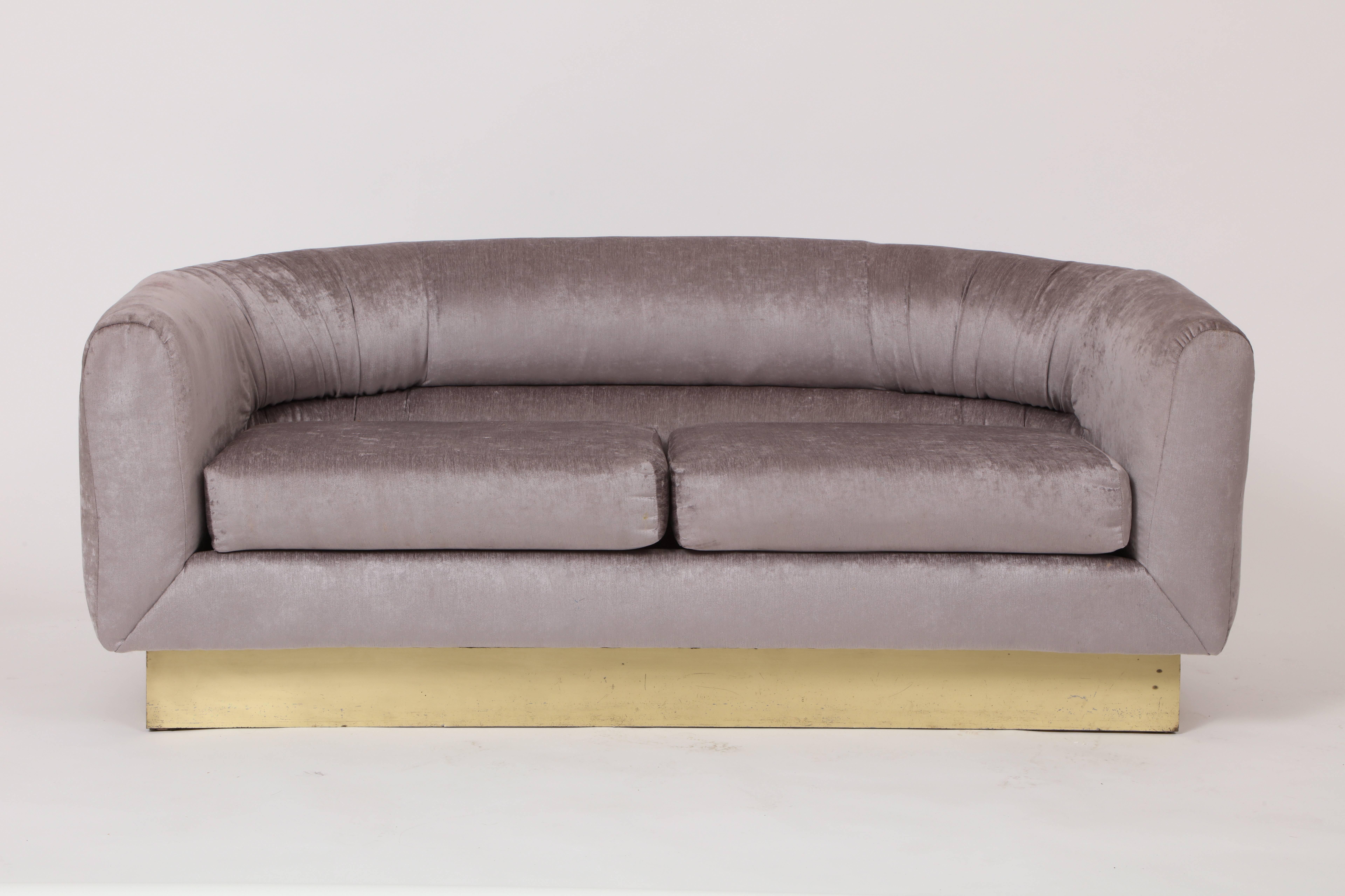 Milo Baughman for Thayer Coggin attributed velvet platinum grey settee sofa on brass plinth, 1980
Newly upholstered Milo Baughman settee on brass plinth
Crescent shape

Measures: 61 inches wide
32 inches deep
24 inches height.