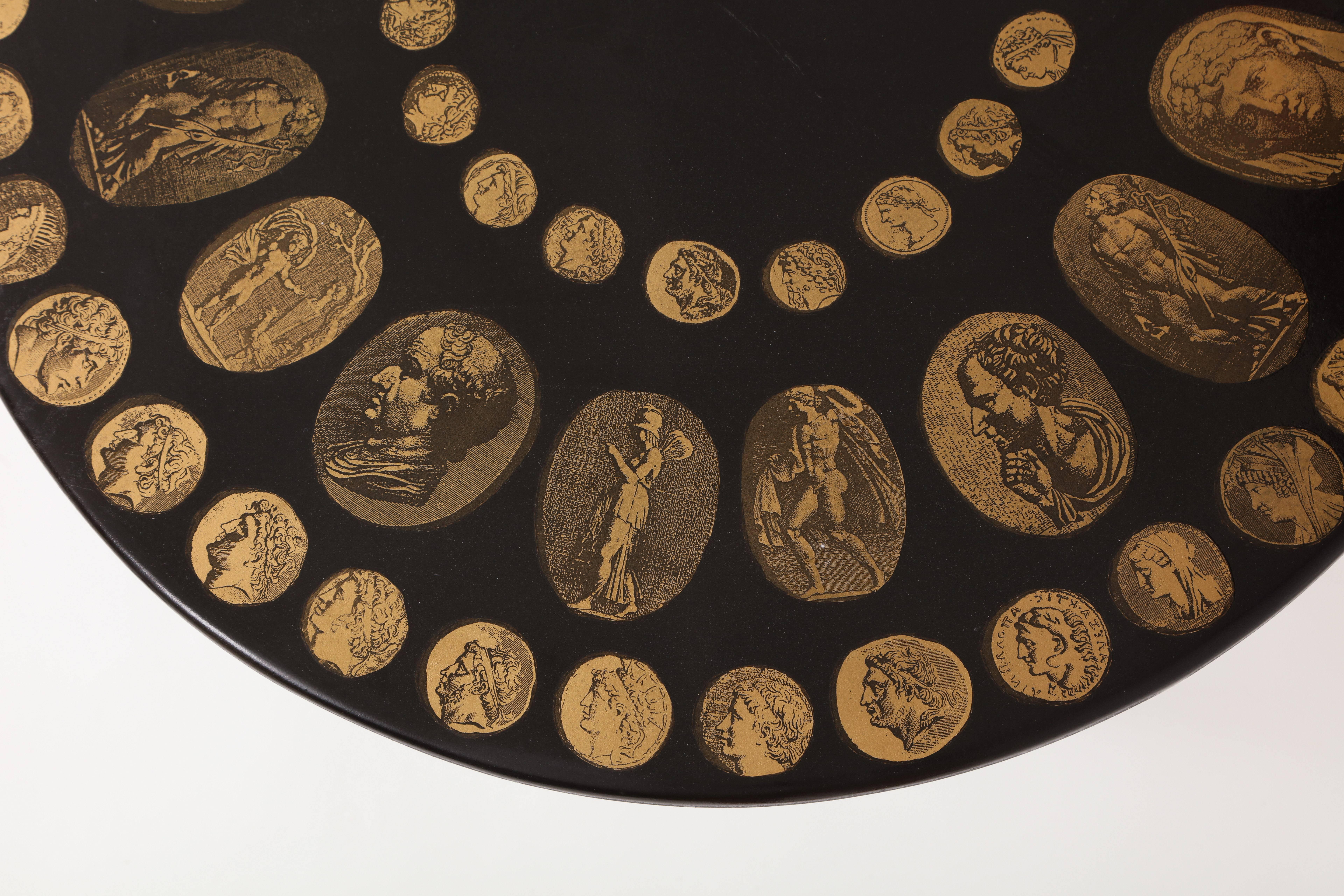 Fornasetti Table Cammei Coin Motif Mid Century, Italian, 1950 1970 Black and Brass
Beautiful coin motif side table with brass legs and lacquer wood top.

60 cm diameter
57 cm height

Piero Fornasetti (10 November 1913 - 9 October 1988) was an