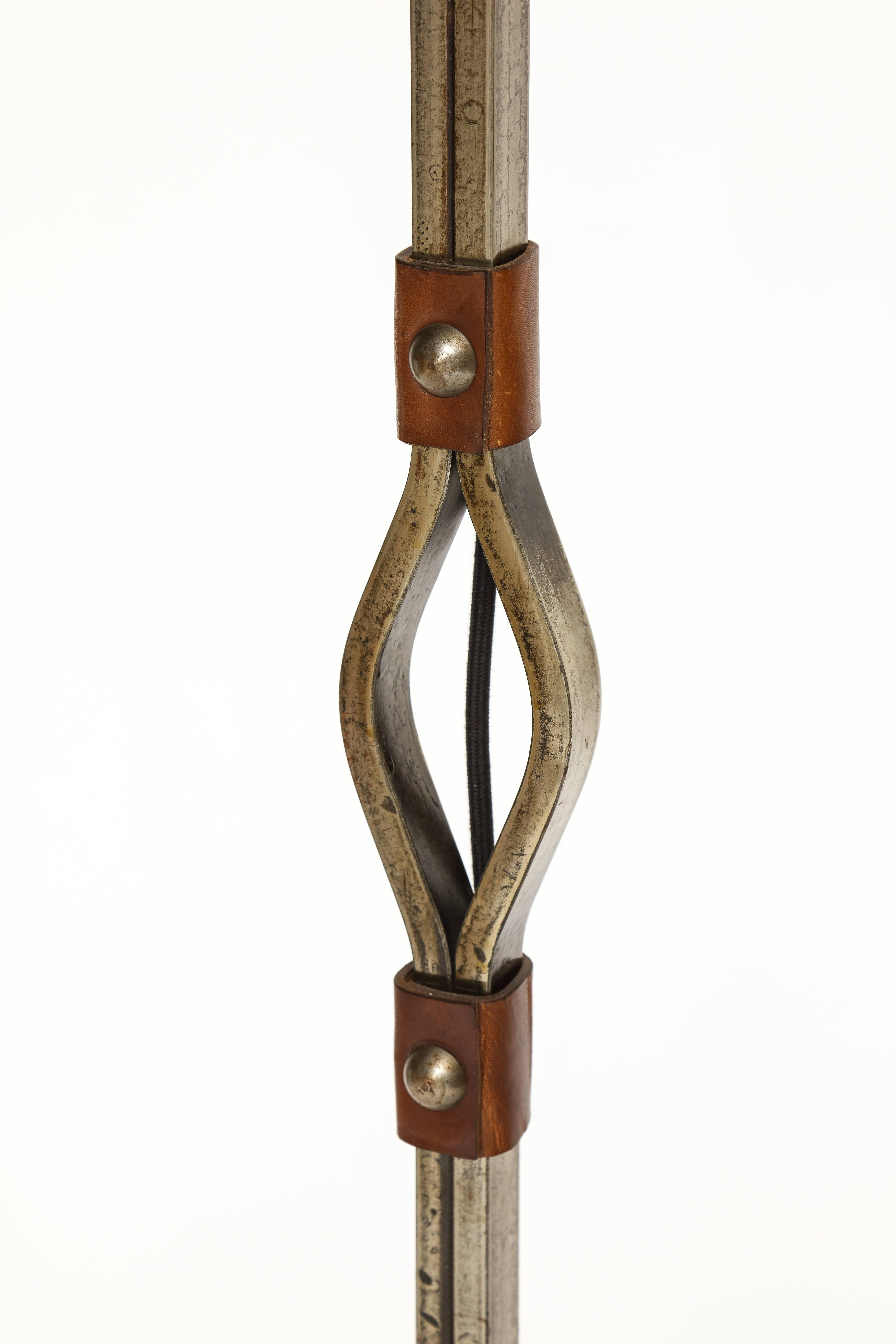 Jacques Adnet iron and leather horseshoe lamp, 1950s-1960s, France.

Beautiful patina to the iron and leather. The lamp is very heavy. Linen cord and black paper shade. 

Measures: Height: 65 inches,
width at bottom: 10 inches,
 Width at
