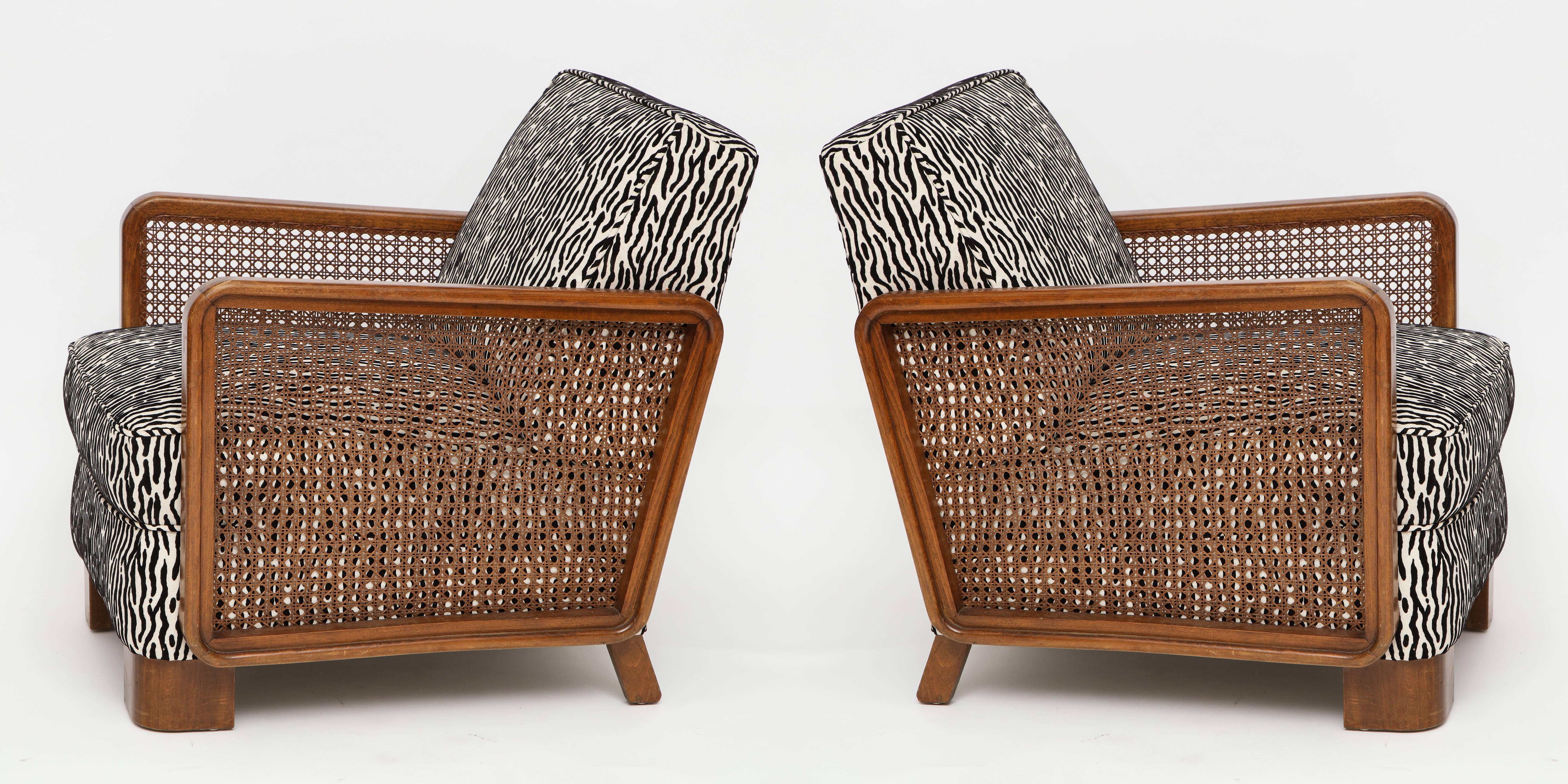 Pair of deco cane lounge chairs with black and white animal print, France, 1940s

Chic pair of French canned lounge chairs with beautiful linen and velvet animal fabric. Newly upholstered.
     