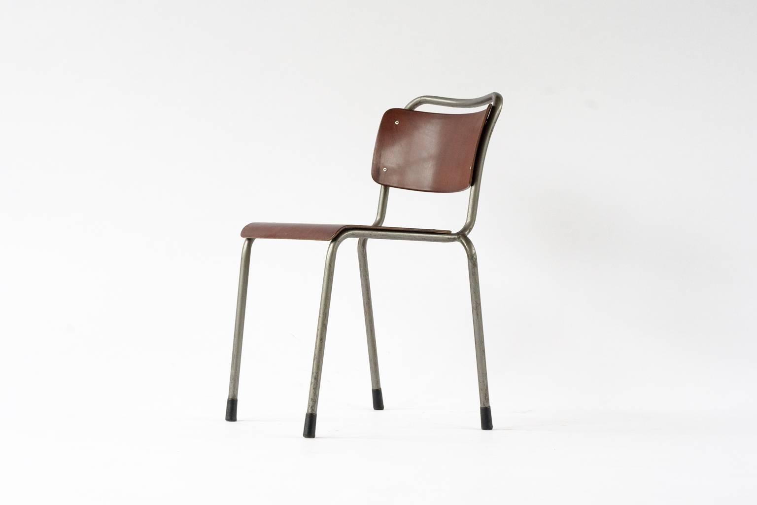 Dutch Industrial Gispen school chairs. This model is known as the ‘Th. Delft seat’ designed in 1952 for the Technical University Delft by W.H.Gispen. These chairs have a light grey metal frame with mid brown wooden plywood seating and back. Slight