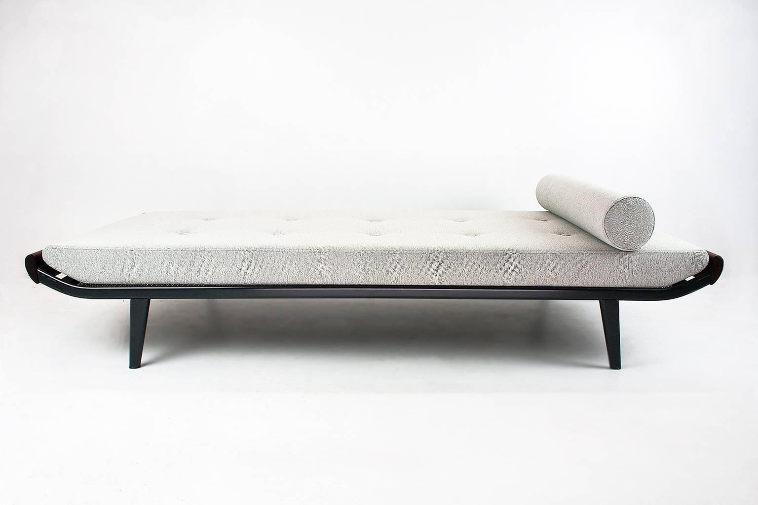 New upholstered Cleopatra daybed designed in 1953 by Dick Cordemeijer for Auping (Holland). The frame is made of dark grey coated metal and the ends are in solid teakwood. The springs are in excellent condition. This piece is upholstered in a good