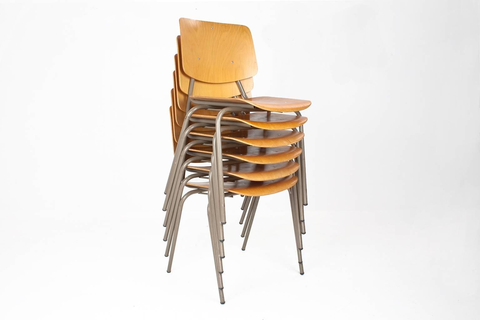 Dutch Industrial stock of school chairs (or dining room chairs) by Kho Liang Ie. Kho Liang Ie designed these chairs for CAR Katwijk (NL), model 305 design. 

Grey metal frame with mid brown moulded seating and back. The items are in good condition