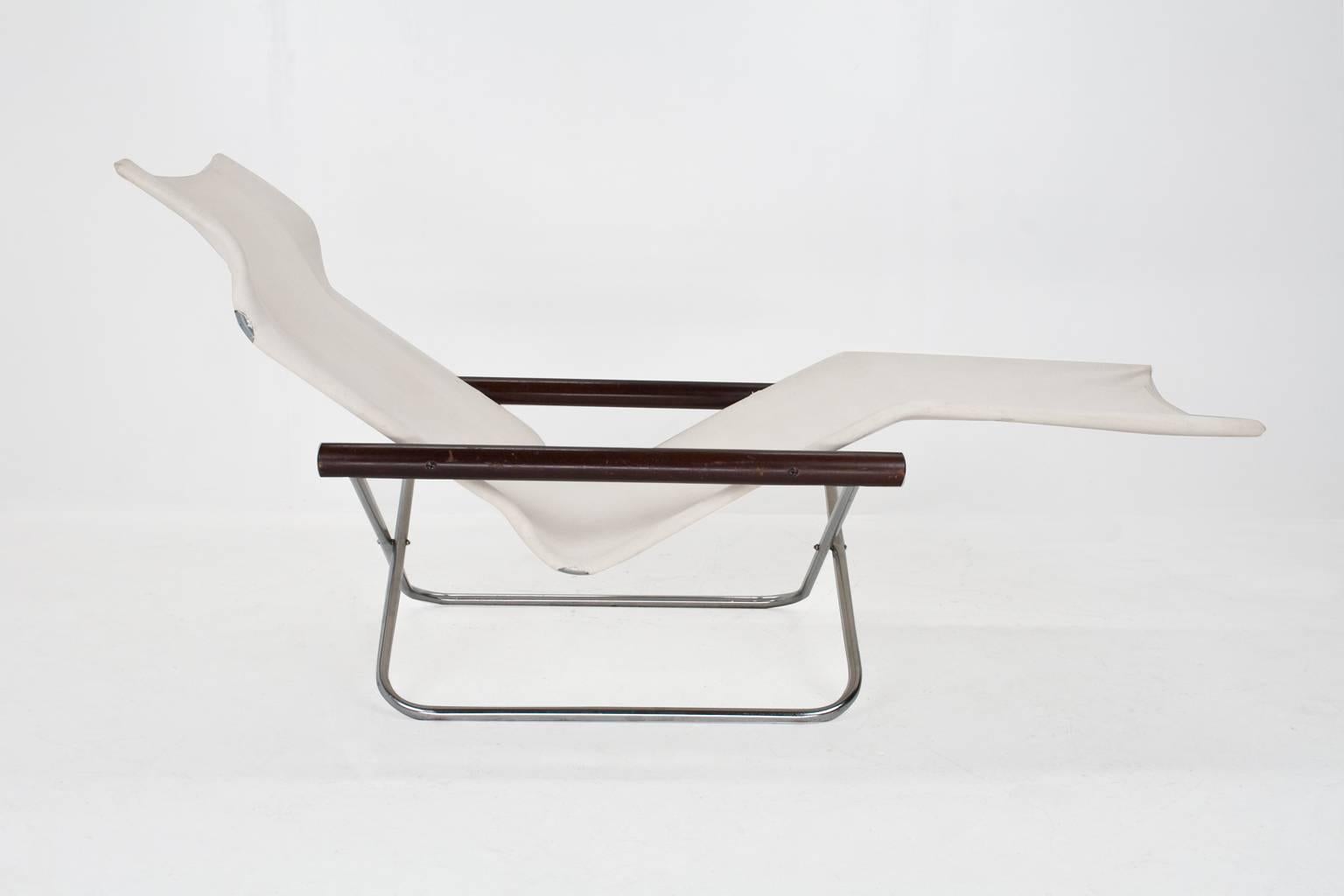 Takeshi Nii "NY" folding chaise longue chair. Chromed tubular metal frame with beechwood supports and off-white canvas sling seat, original condition. The fabric is intact and in good shape, but has spots conforming use. The design was