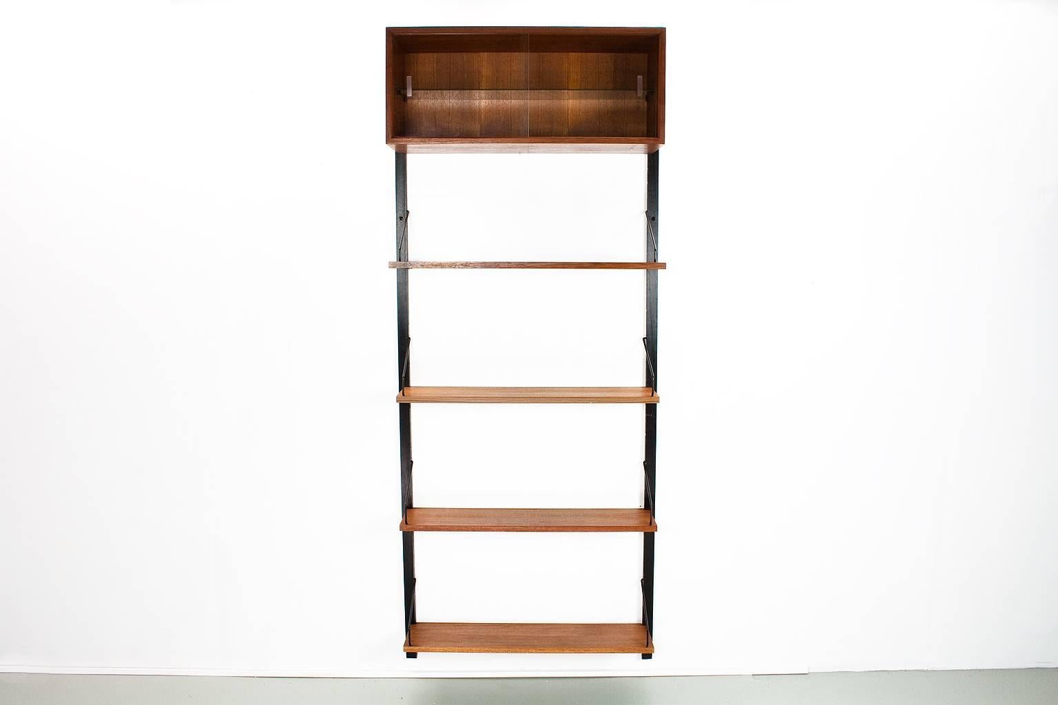 Original mid cenutyr modern Danish wall unit, model Royal, designed by Poul Cadovius in the 1950s for Cado, Denmark. This listed unit was produced by Cado in Denmark in the 1960s. The elements features a lovely quality teak veneer with black