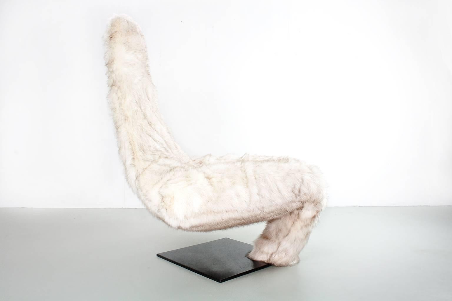 Limited edition 1982 'Turner' lounge chair, re-upholstered in a very high quality long haired faux fur (Siberian cream) on a black lacquered metal, heavy foot. The design has a high comfort. 

The chair was designed by Jack Crebolder for Harvink,