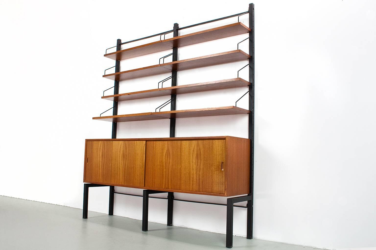 Original freestanding Mid-Century Modern wall unit designed by Poul Cadovius, model Royal, in the 1950s for Cado, Denmark. This listed unit was produced by Cado in Denmark in the 1960s. The elements features a lovely quality teak veneer with black