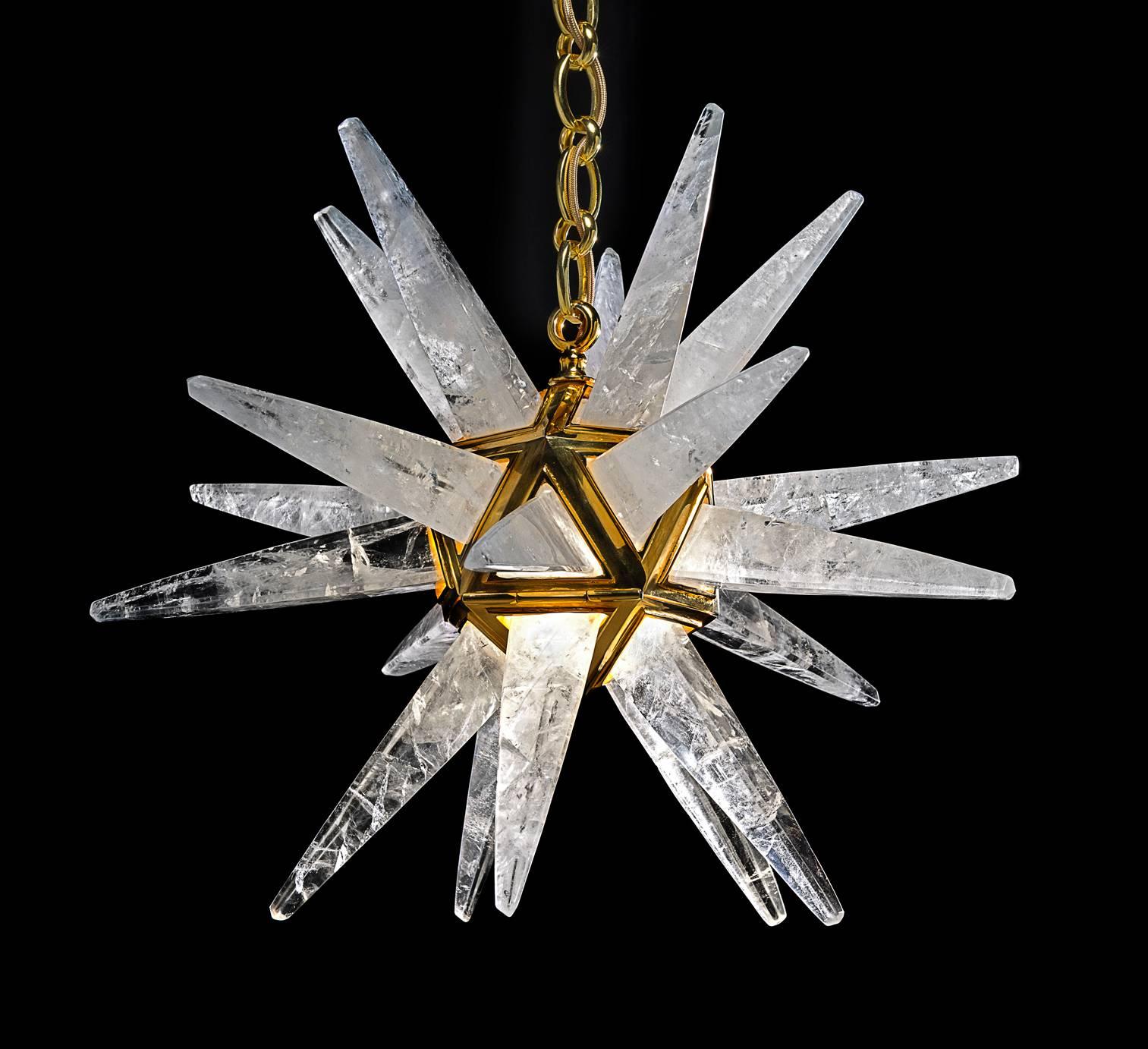 Rock crystal  quartz star III light gold edition. The fixture, the chain and the canopy of this rock crystal lighting are handmade in bronze. Each workers who belongs from a corporation made their work in the pure tradition of the 18th century. All