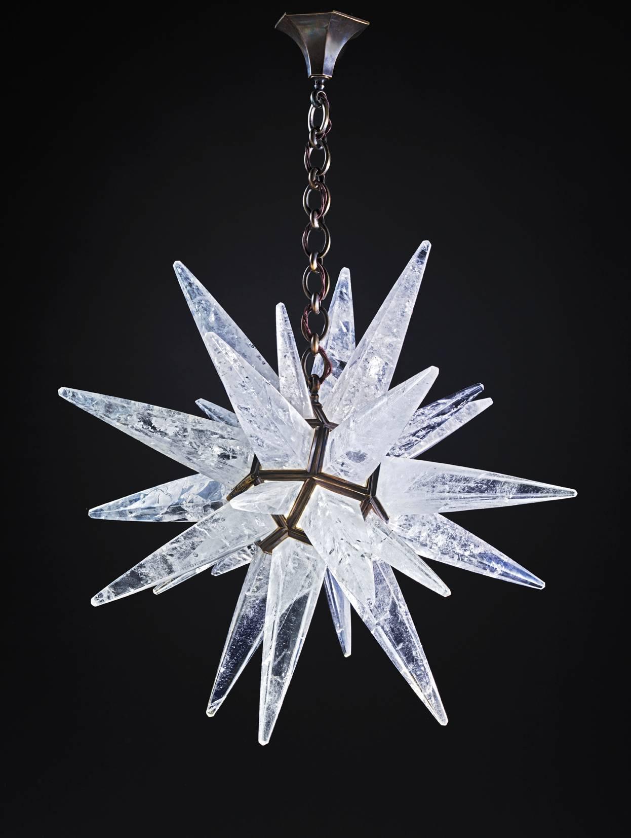 Rock crystal quartz star I light antique brass edition.
This patina is made by qualified worker with acids which are burn to a fire, so this color come into the bronze of the fixture for ever and make a patina like a bronze sculpture. Since 2011