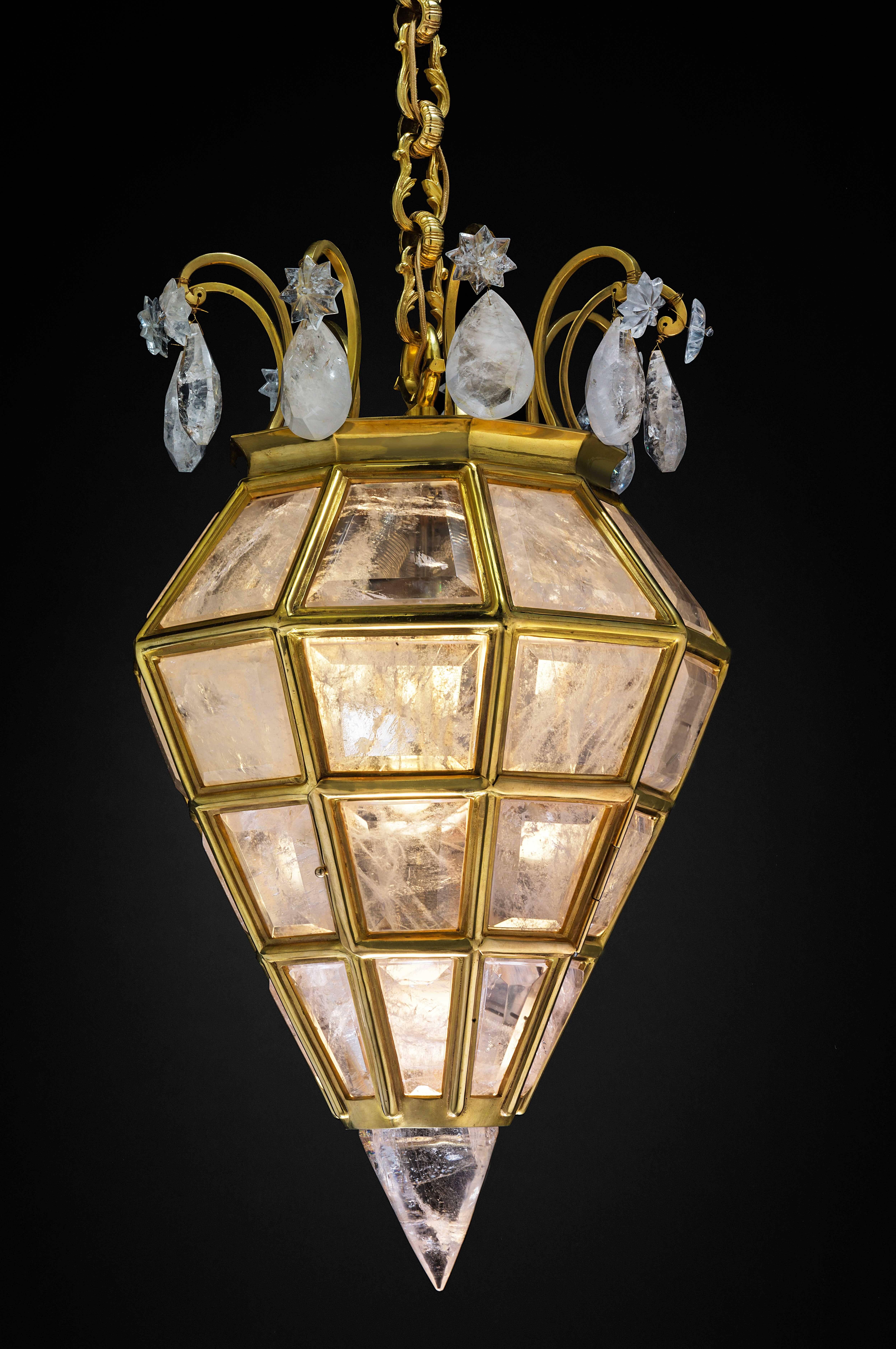 Rock crystal  quartz and ormolu bronze lighting by Alexandre VOSSION.
This rock crystal lighting is made in France. The fixture, the chain and the canopy of this rock crystal lantern are handmade in bronze. Each workers who belongs from a