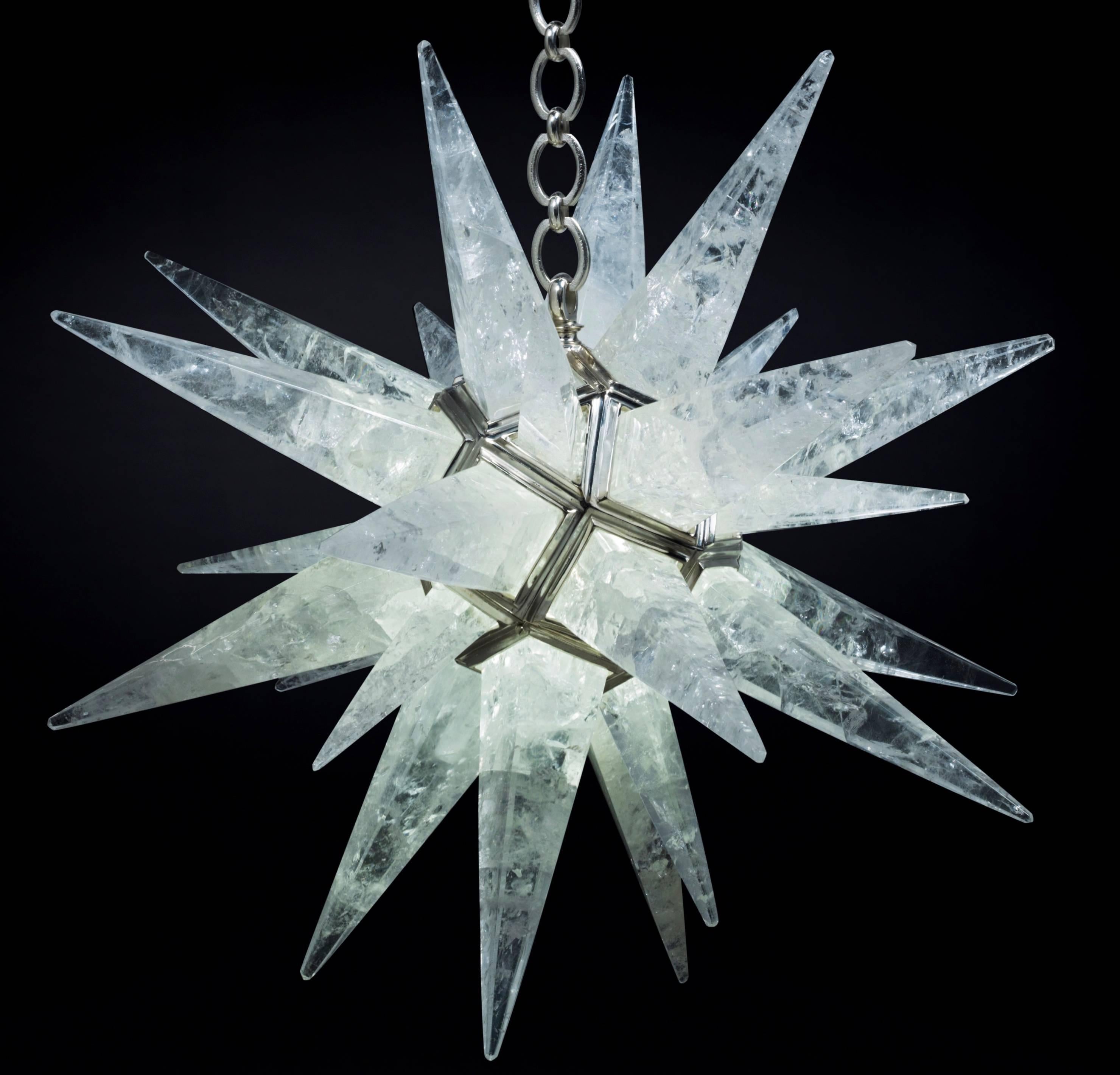 Rock crystal quartz  star I light silver edition 
This rock crystal star lighting is made in France.
The fixture, the chain and the canopy of this rock crystal lighting are handmade in bronze. 
Each workers who belongs from a corporation made their