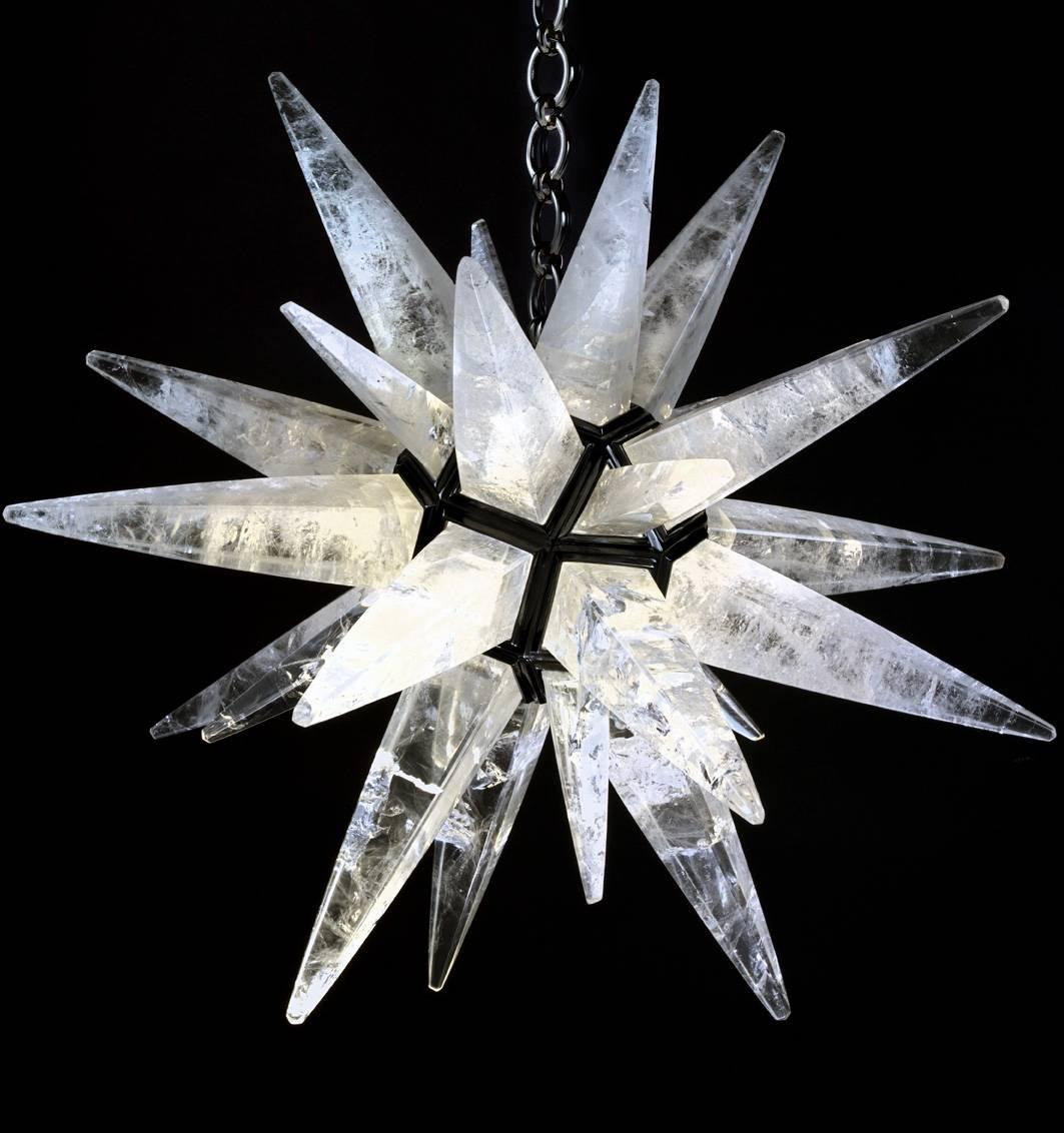 Rock crystal quartz star light black edition.
This rock crystal star lighting is made in France.
The fixture, the chain and the canopy of this rock crystal lighting are handmade in bronze.
This rock crystal light could be also customized in other