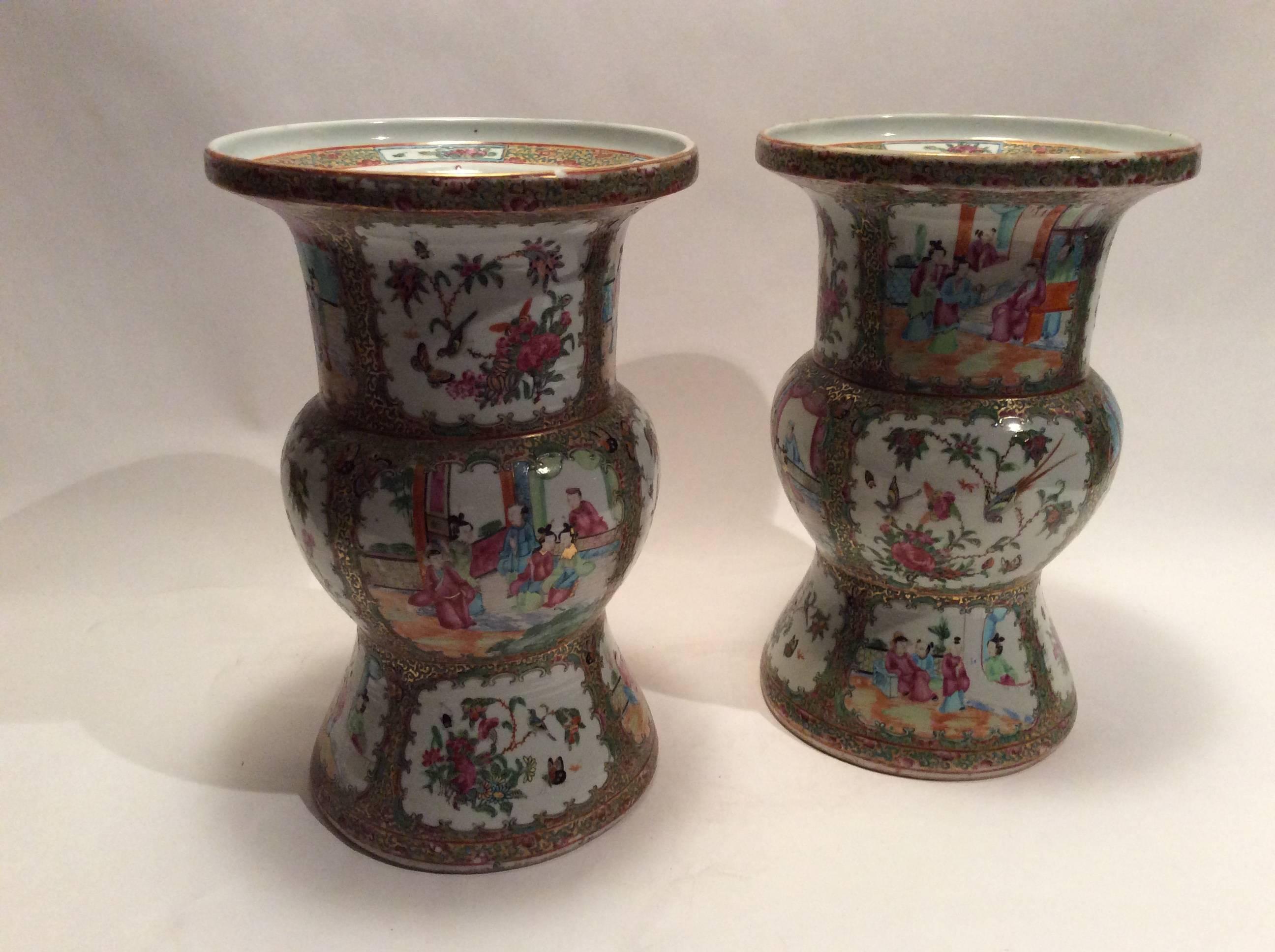Cylindrical vases with flared rims, these pair have been in one family for over a hundred years. Features cartouches surrounded by scrolling green and gold borders.
Alternating scenes of nature and indoor scenes depicting people in conversation.