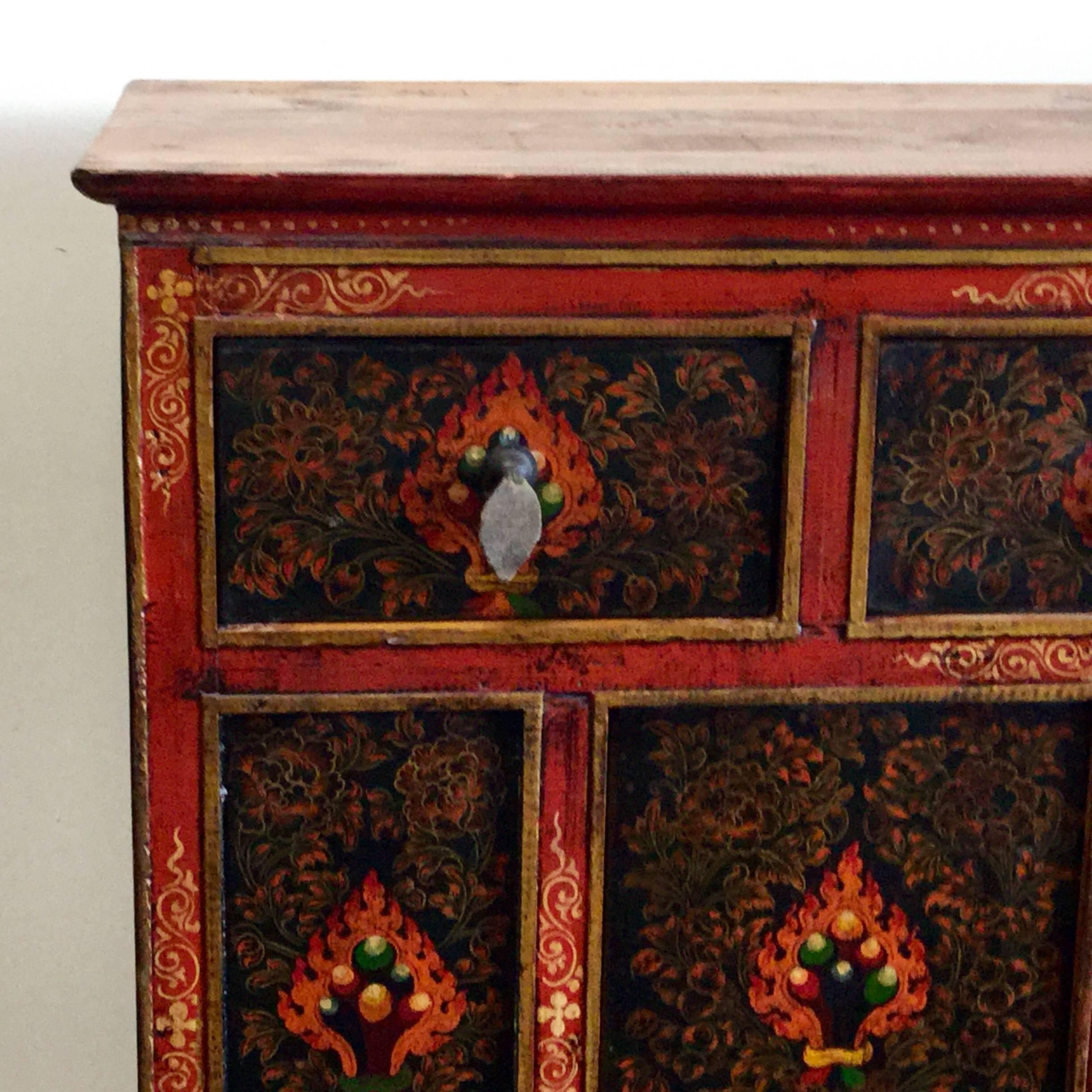 With three drawers and a cabinet beneath, this piece provides ample storage. It has been hewn from elmwood.
 