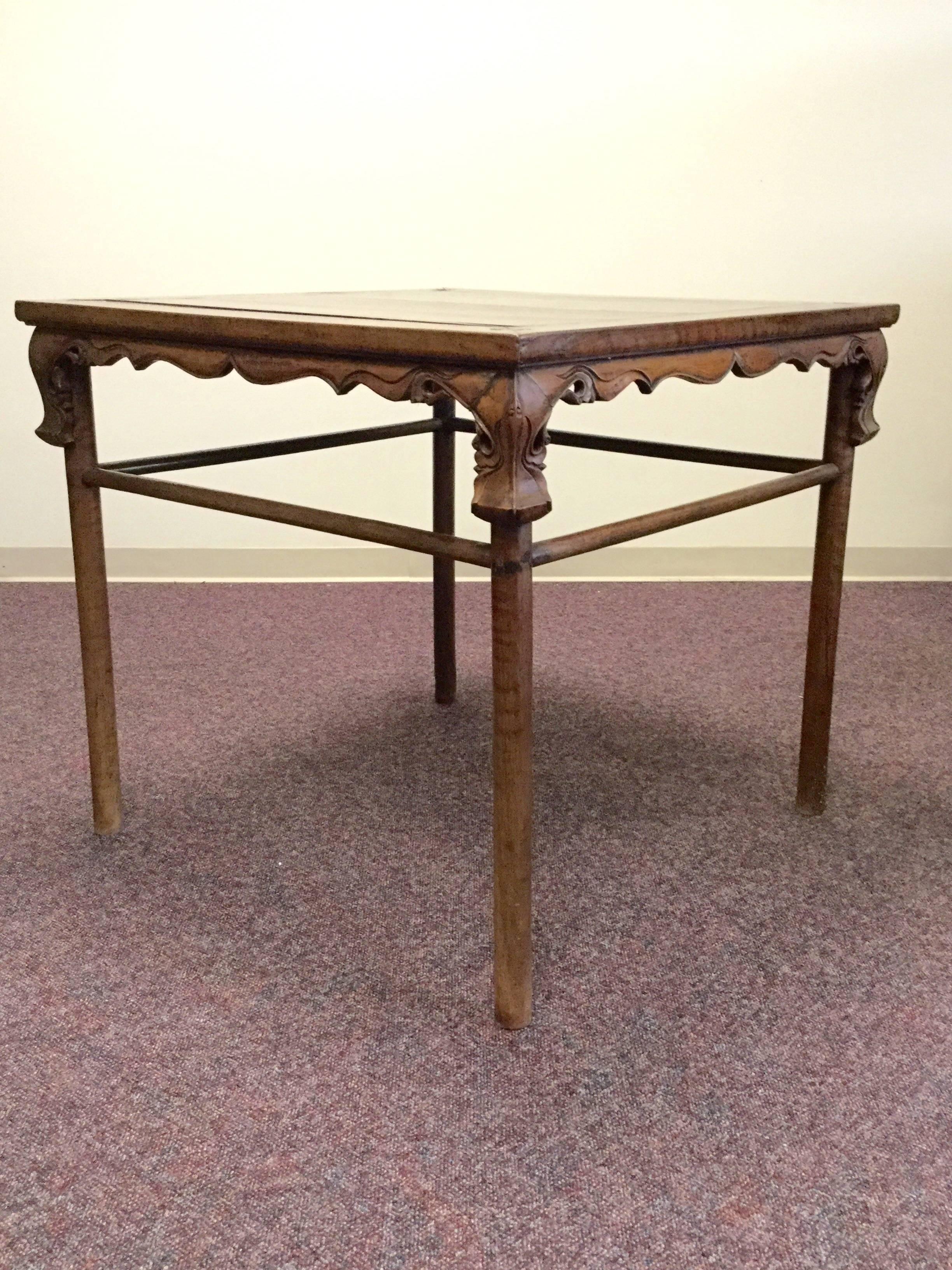 This fabulous table dates from the early 1800s and is hand-carved from walnut wood in Shanxi province. Notice the graceful non-linear curves of the carved details.