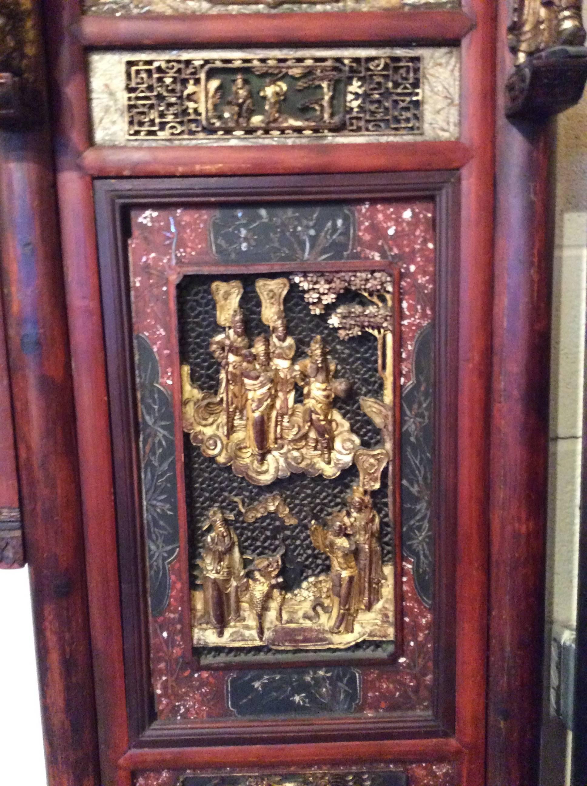 
Detailed pierced carving is present throughout this portion of a Chinese wedding bed. Open fretwork would have let light shine through highlighting the detailed carving.
Carved birds at the top of the piece have movable wings on wire that quiver